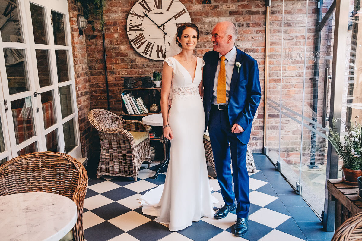 Bride with her father laughs