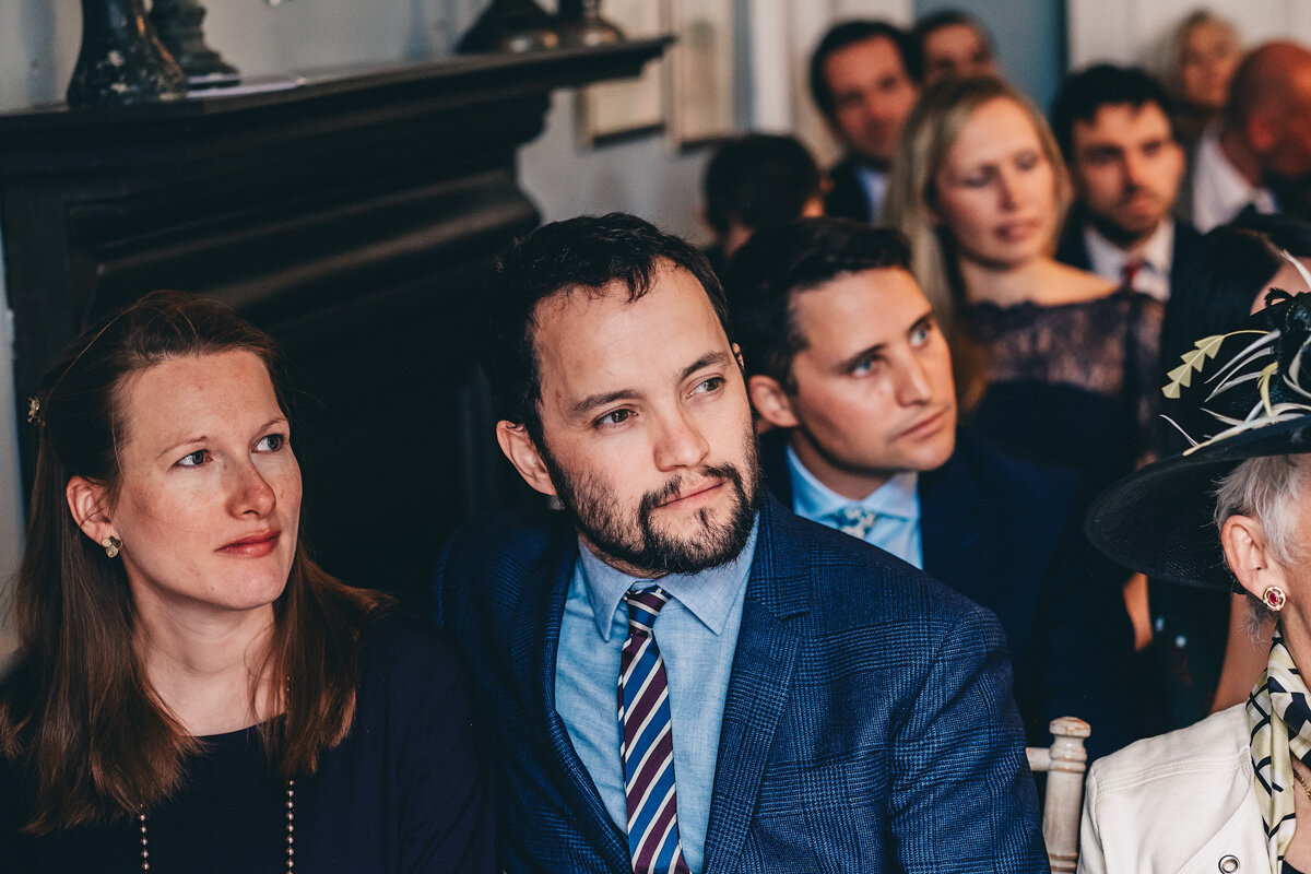 Guest looks on during wedding ceremony
