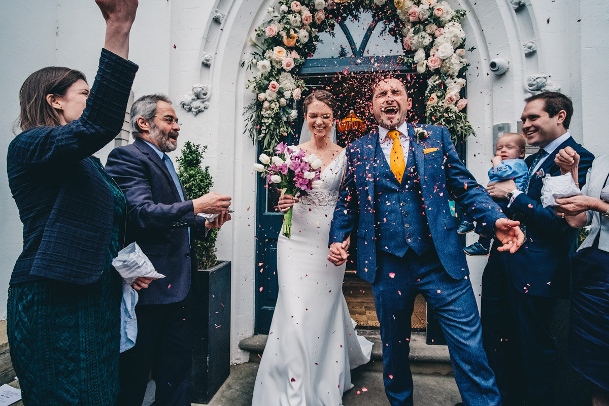 Confetti is thrown at bride and groom
