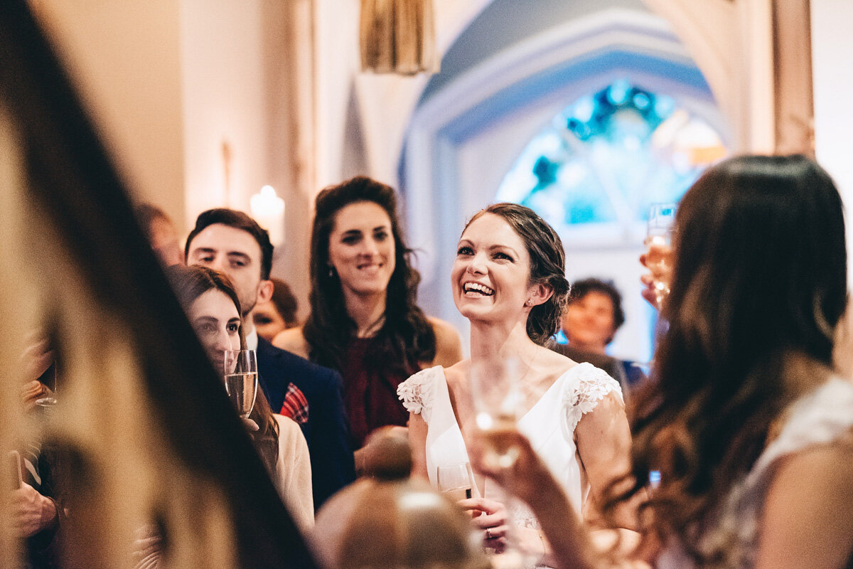Bride laughs at grooms speech during their wedding
