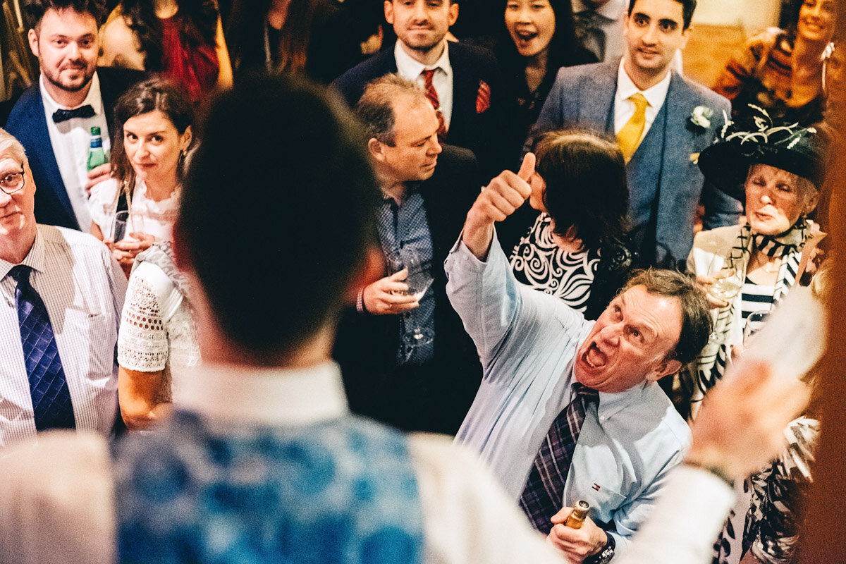 Guest gives the thumbs up at wedding