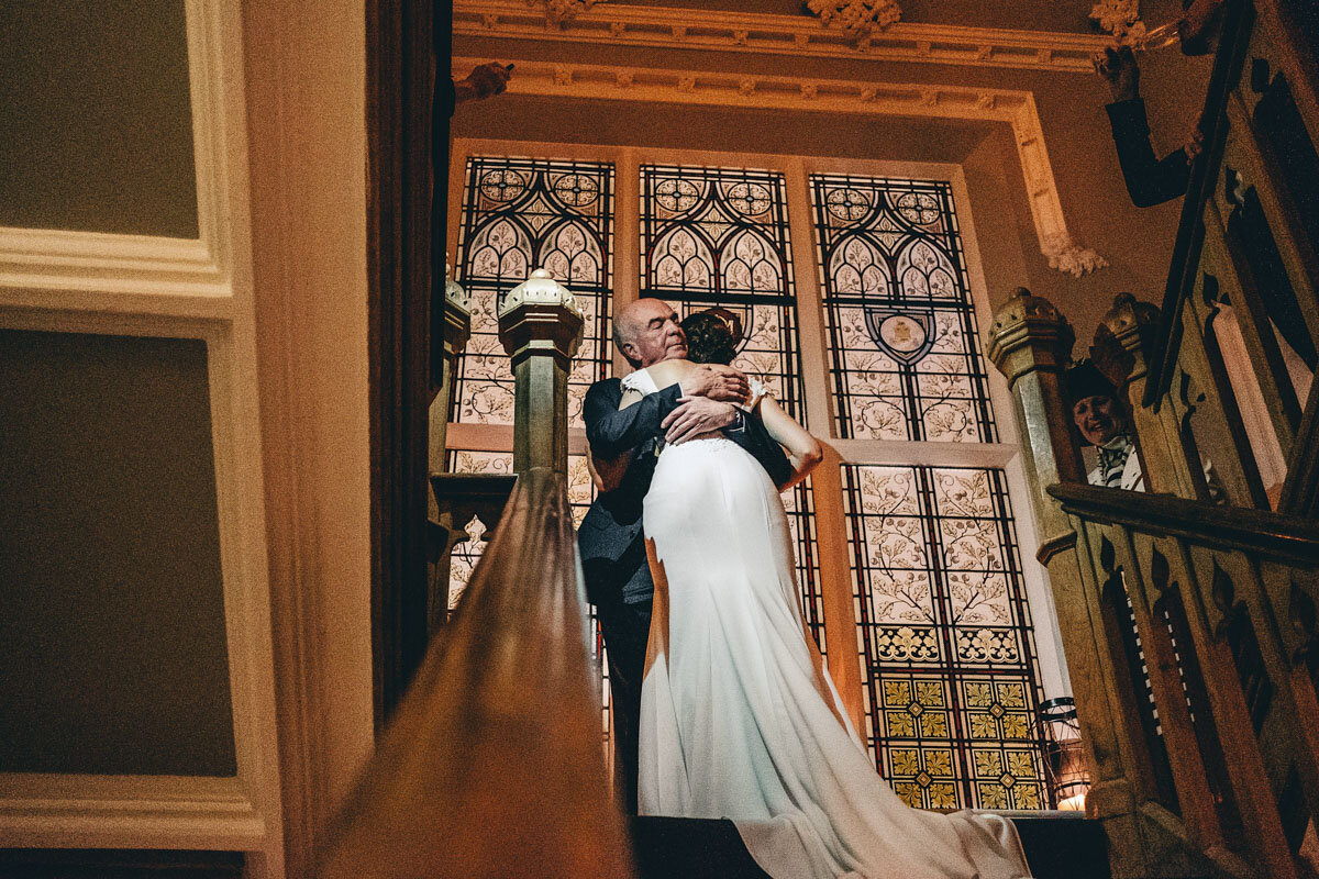 Bride hugs Father after his speech on staircase