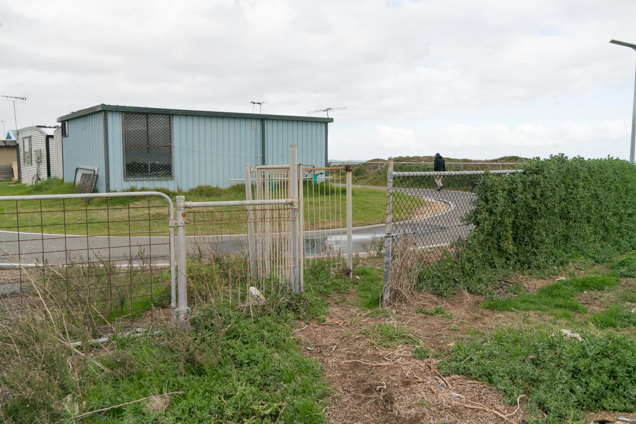Plate 18: Gate into the shack settlement at Naval Base