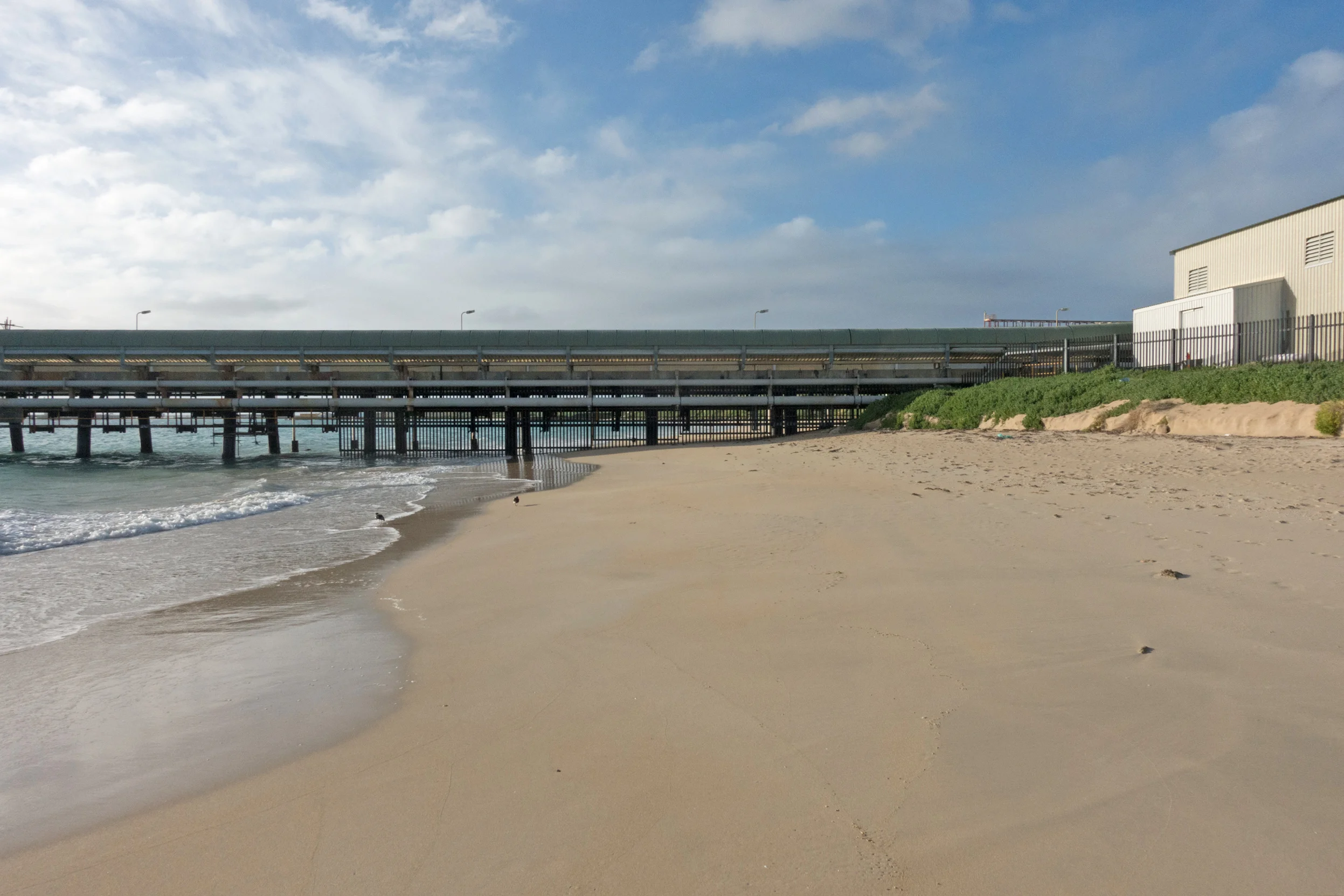 Plate 5: Close up of the jetty showing the gates underneath the jetty blocking further access and the property fence prevent access around it.