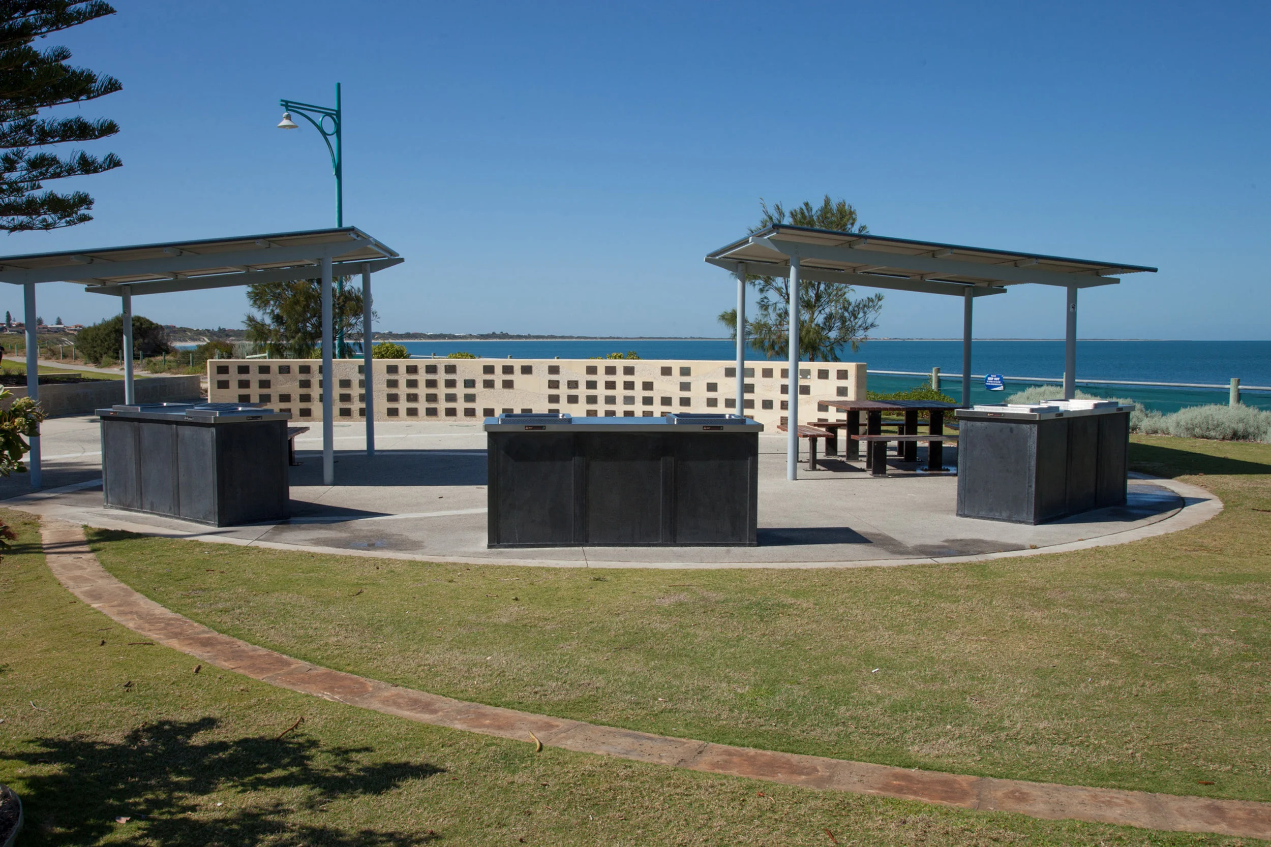 Plate 6: Wall with Memorial plaques at Waikki beach.