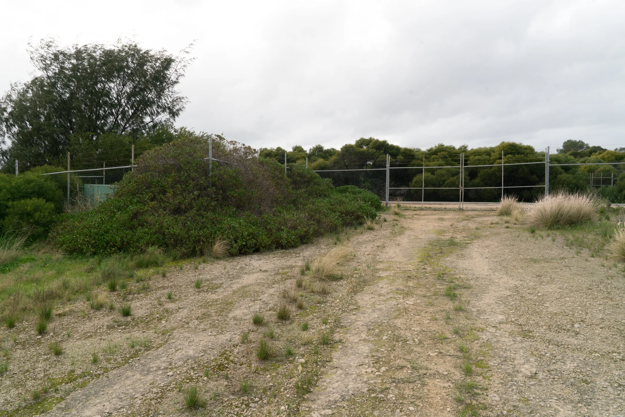 Plate 17 and 18: Track along the fence at the boundary of the Jervoise Bay/Henderson Marine Industrial Estate, and closed gate and fence at the end of the track