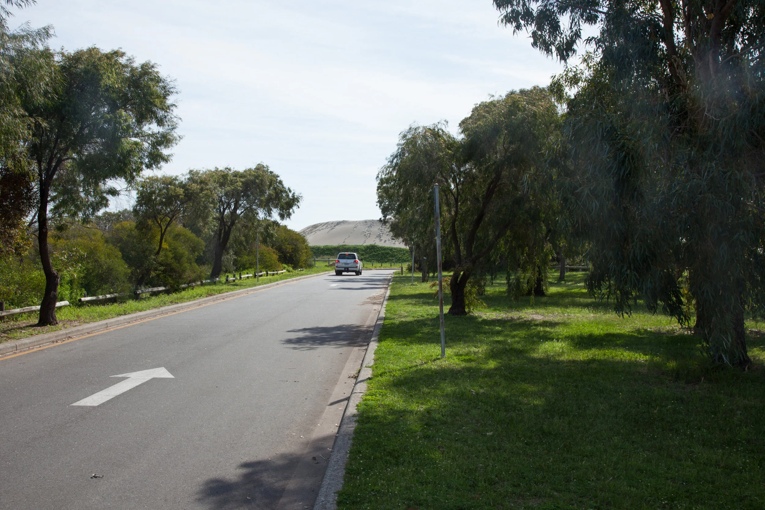 Plate 16: Road through the carpark for the boat launching facility just west of the Causeway – note the pile of beach sand.