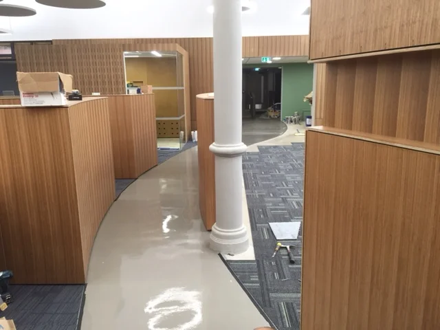  Curved walkway with carpet tiles flush to both sides.