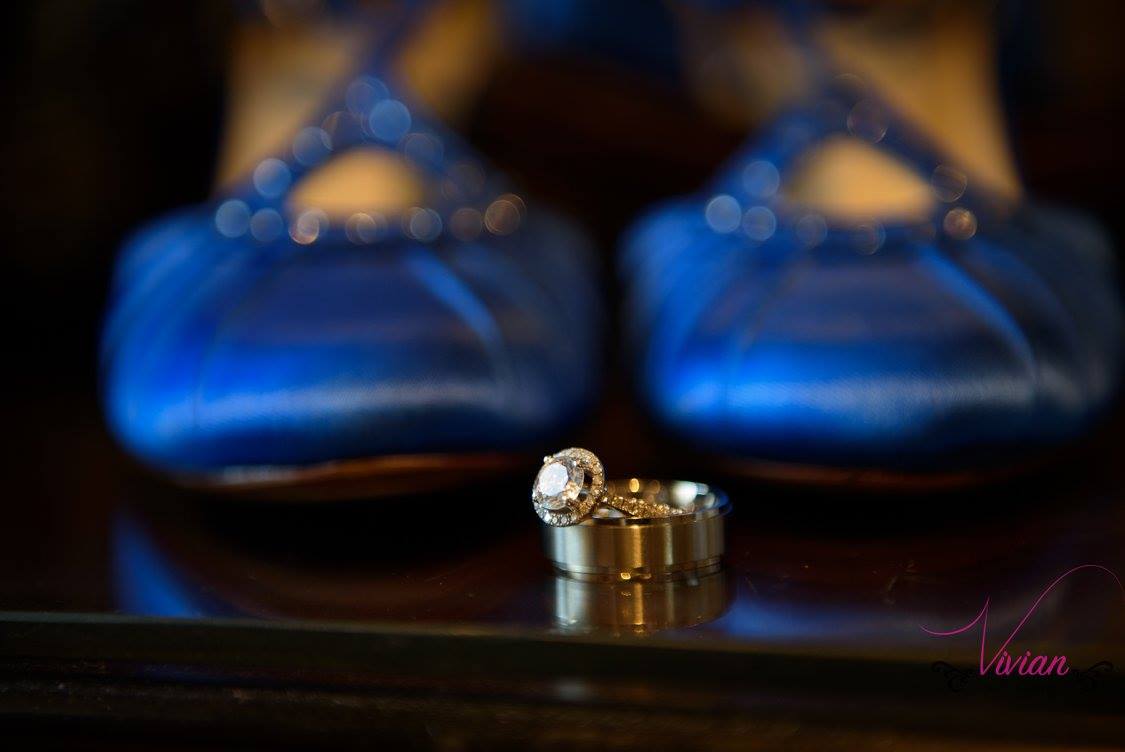 close-up-of-wedding-rings-with-blue-ballet-slippers-in-background.jpg