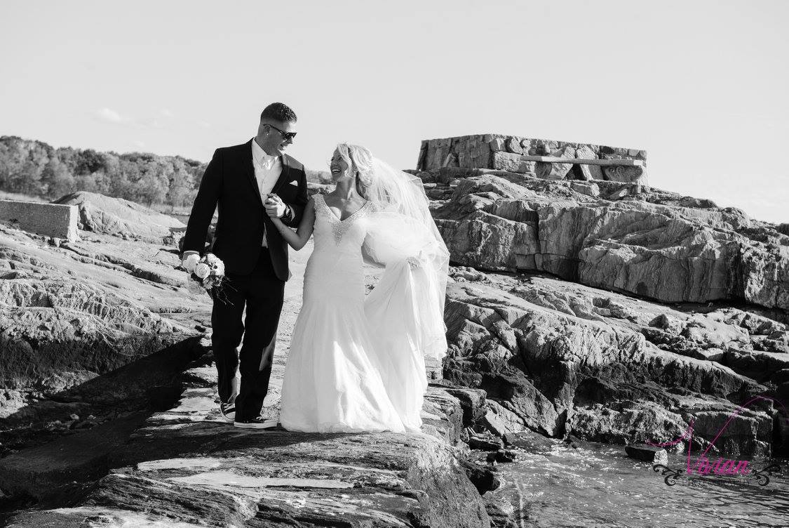 bride-and-groom-walking-through-rocks-near-ocean.jpg