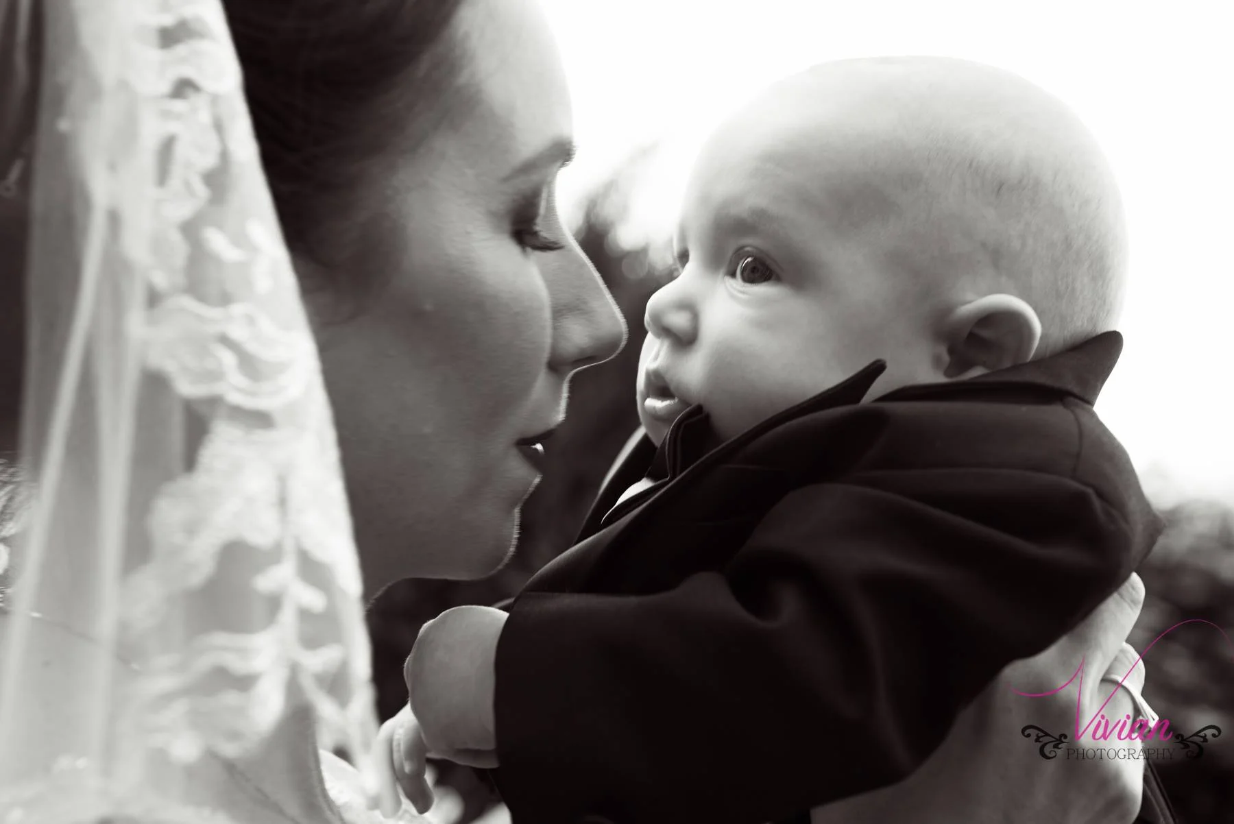 bride-kissing-baby-close-up.jpg
