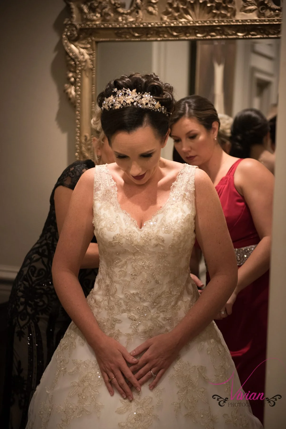 bride-lookin-down-dress-getting-zipped.jpg