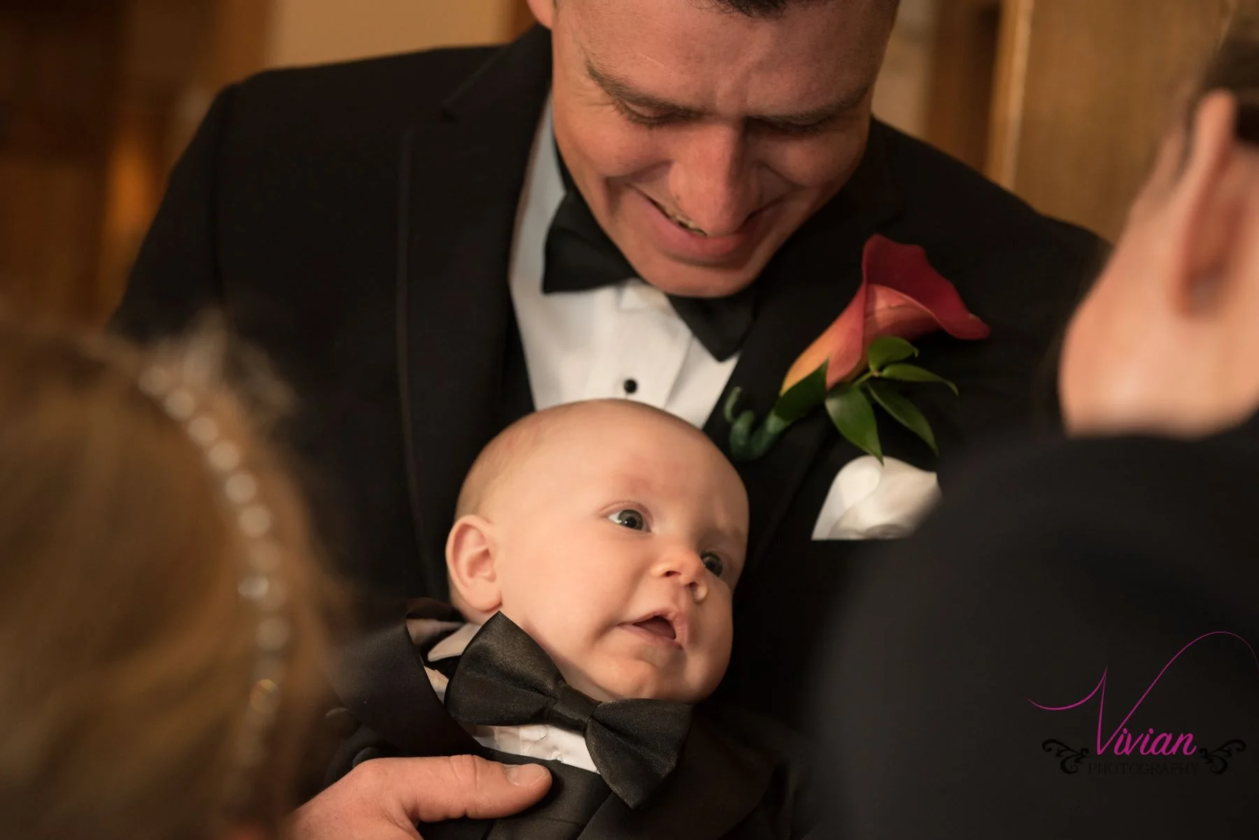 groom-looking-down-at-baby.jpg
