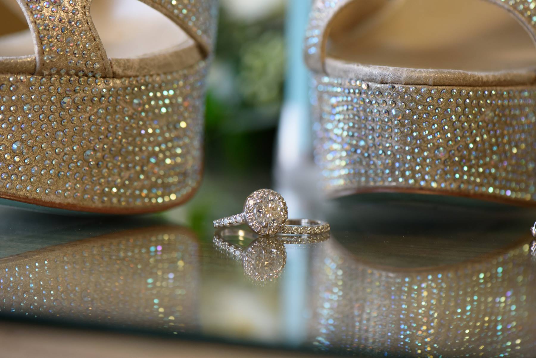 wedding-rings-sitting-between-bejeweled-heels.jpg
