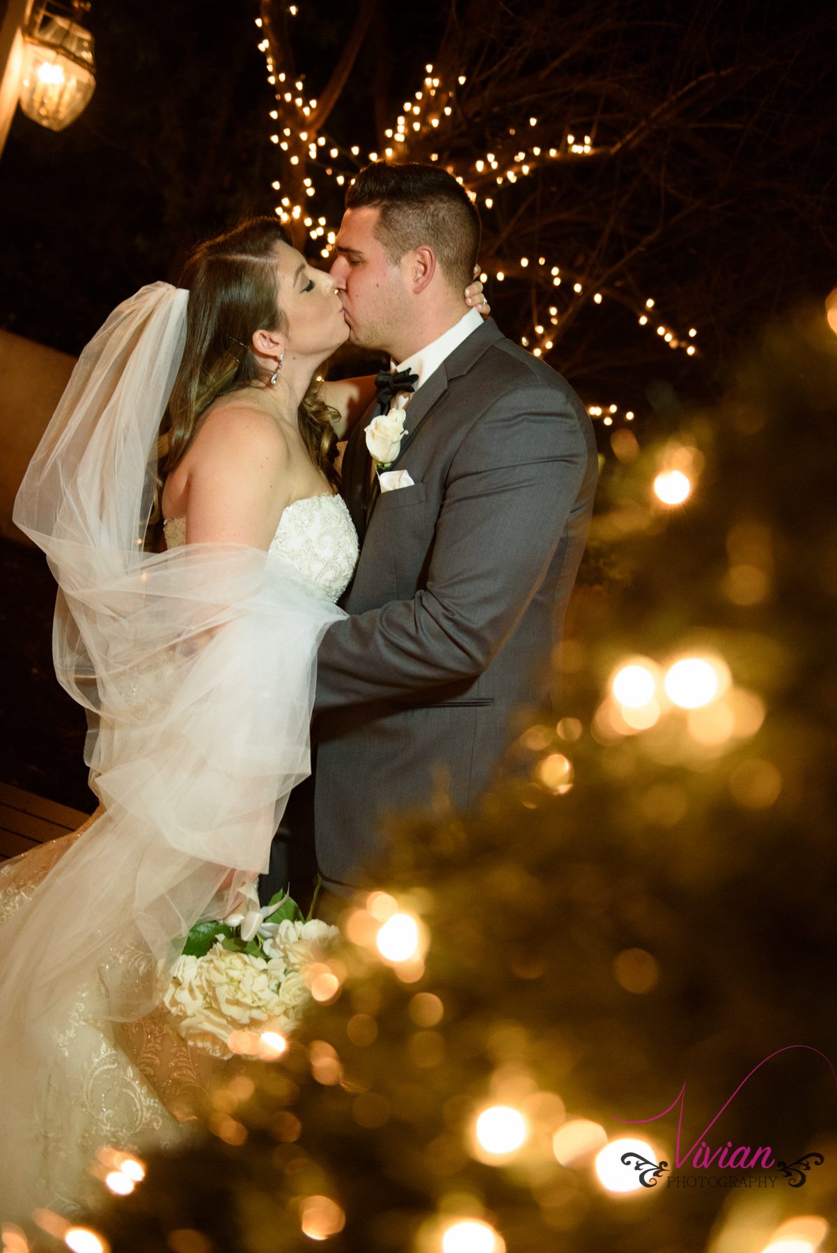bride-groom-kissing-in-christmas-lights.jpg