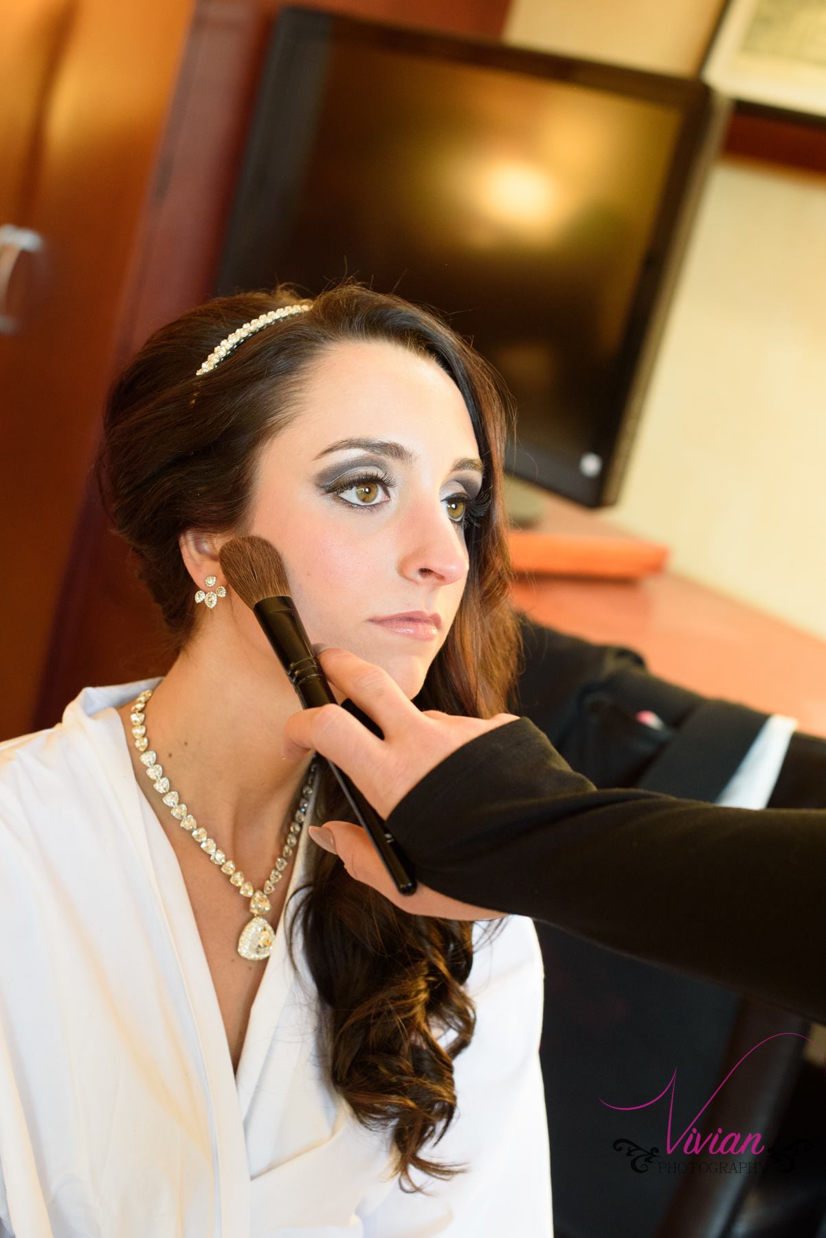 bride-getting-makeup-done-in-robe.jpg