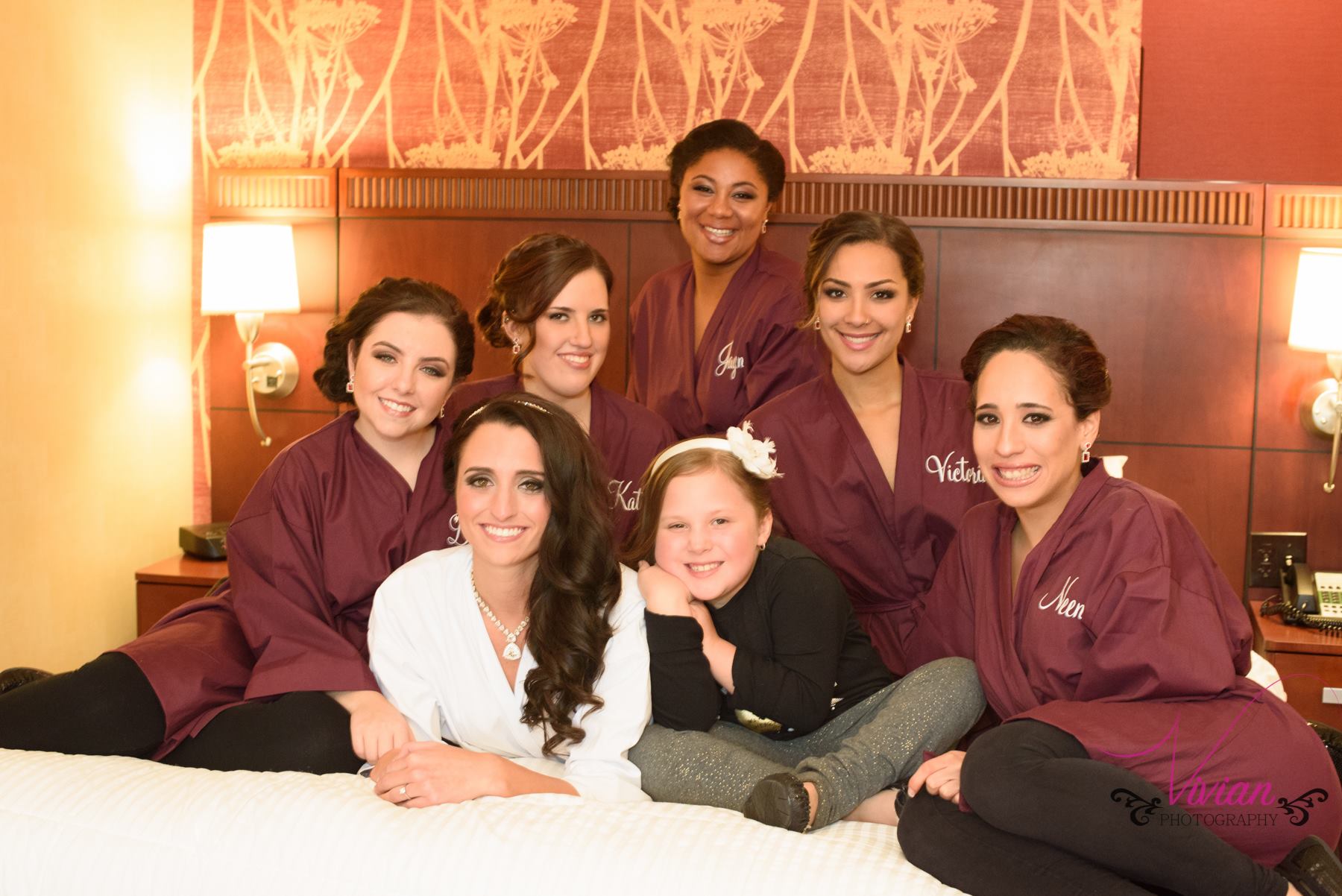 bridesmaids-in-robes-posing-on-bed.jpg