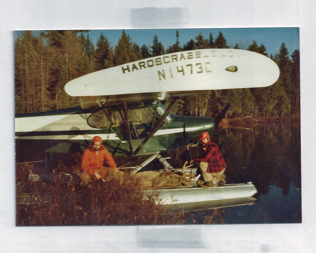 Jake preparing to fly a large deer out of Roaring Brook pond in the Super Cub.