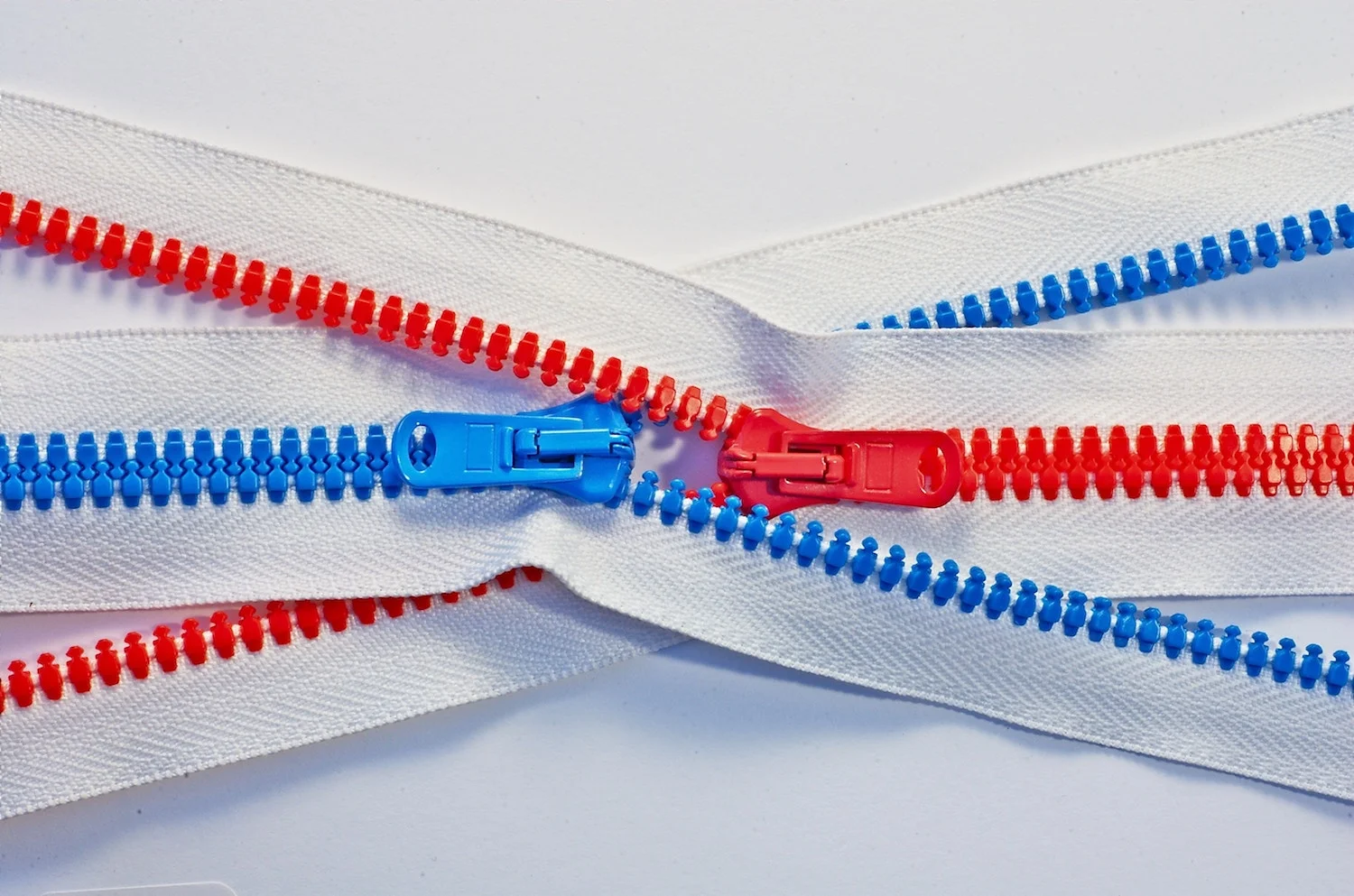 red blue zippers crossing backstory preaching politics tomas-sobek-735207-unsplash.jpg