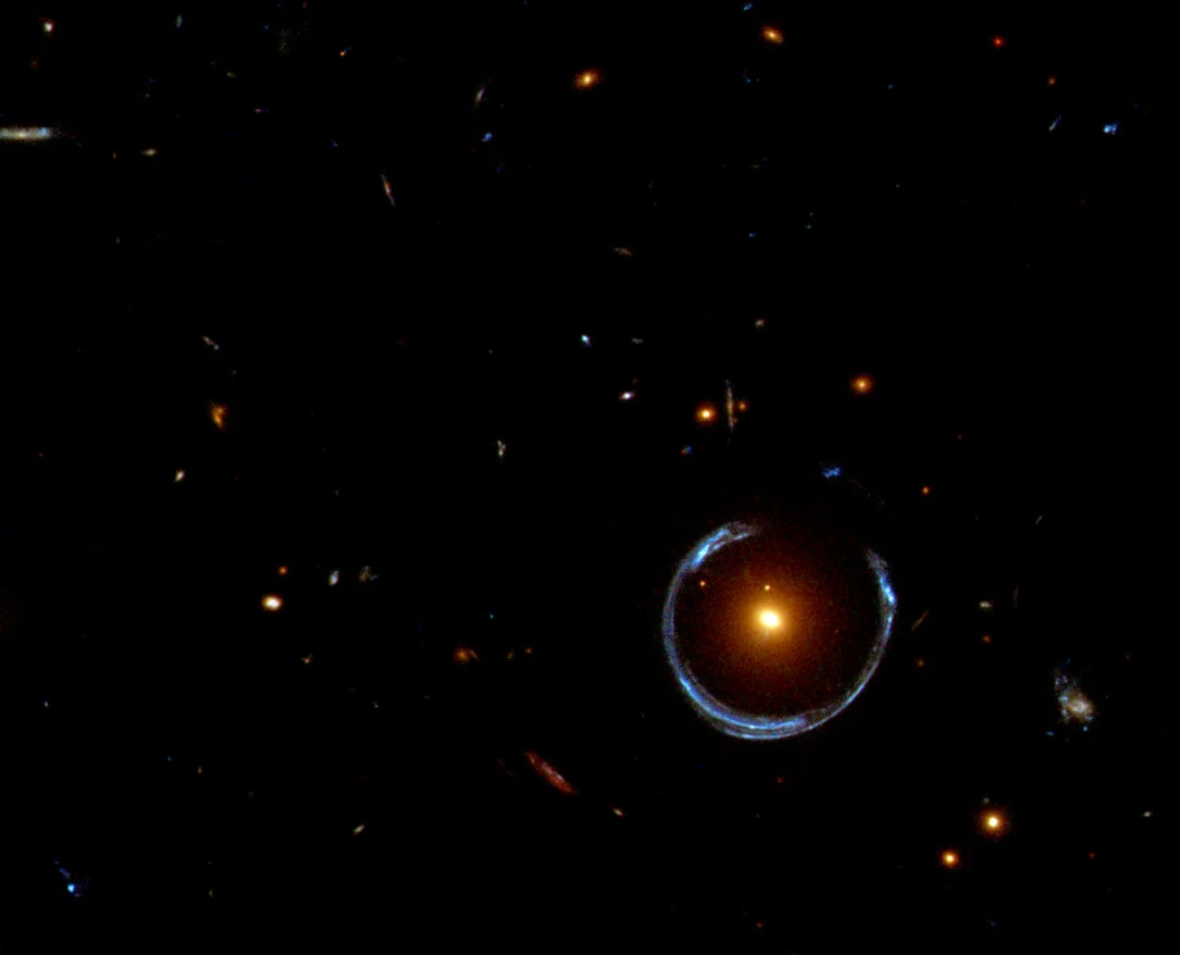 The Cosmic Horseshoe: A Horseshoe Einstein Ring from Hubble. Light is bent around the gravitational pull of a black hole. (Image from ESA/Hubble & NASA )