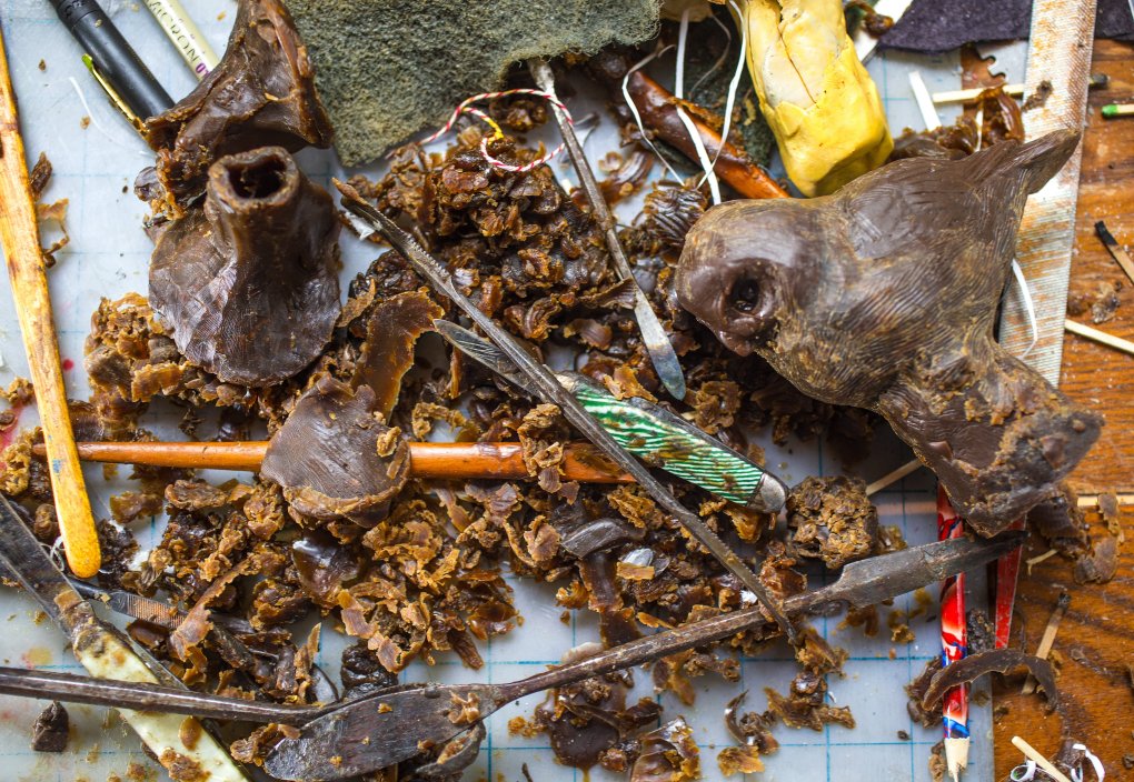 Tony's work table, scattered with wax, tools, and work in various stages of completion. (Mike Siegel / The Seattle Times)