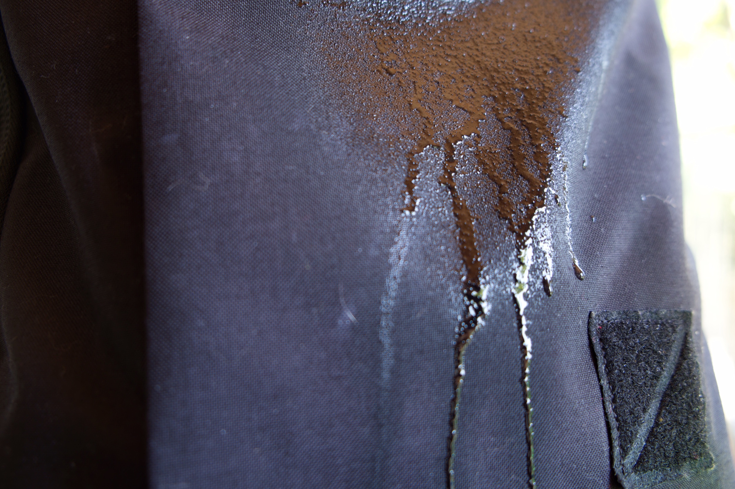 After I sprayed a descent amount of water, I could see the material started to absorb the liquid. This does not mean much and is not scientific at all. I just wanted to see how well the bag photographs with water on it.