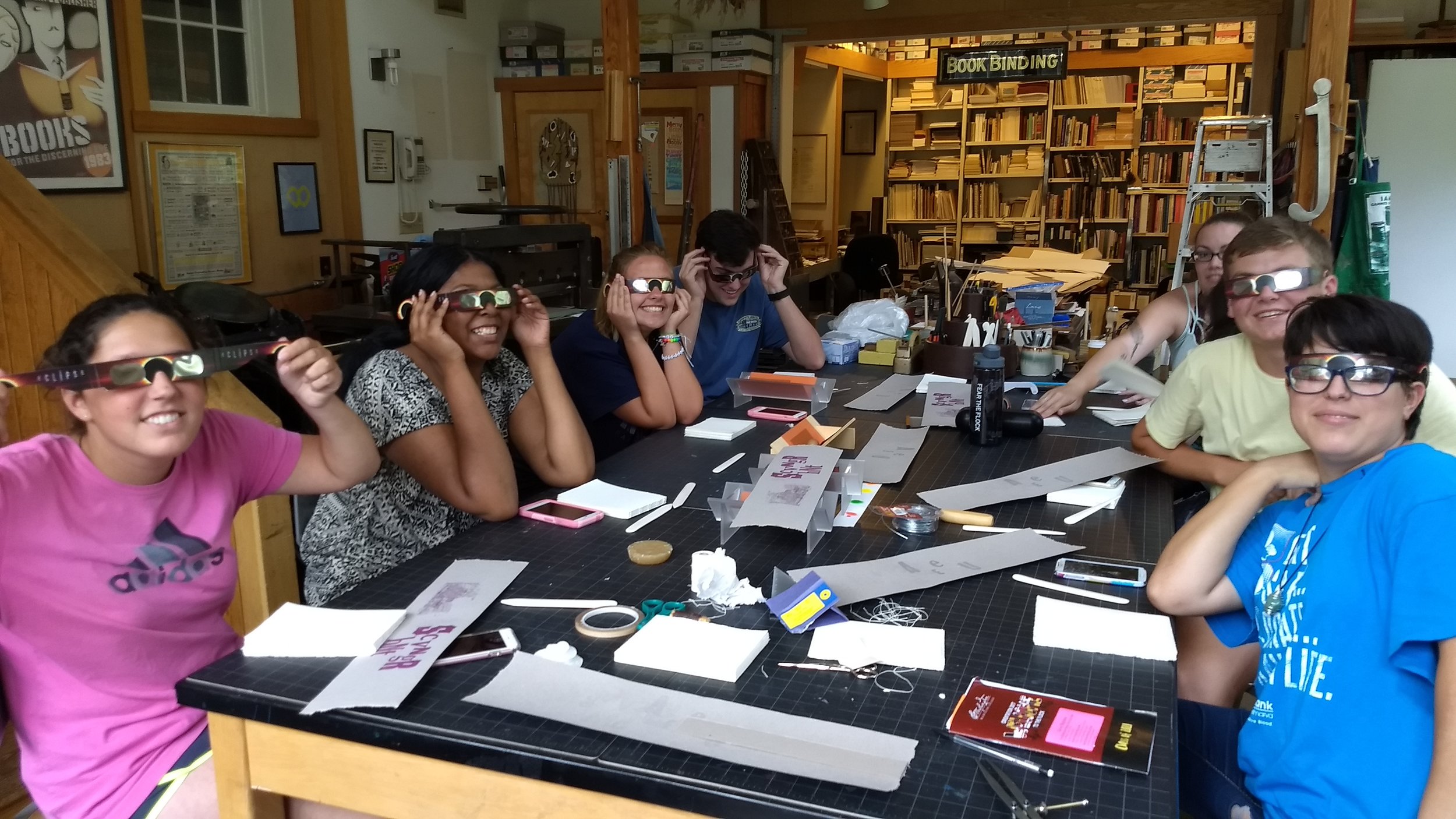 Incoming Washington College freshmen work right through the solar eclipse of 2017 to bind their books,