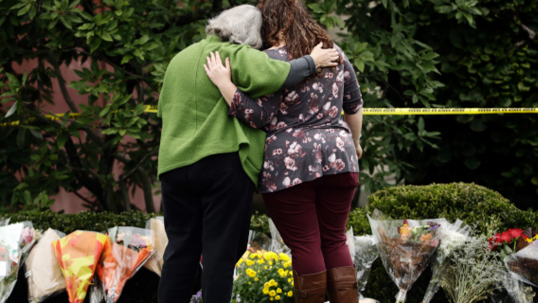 Two women visit the memorial for the October 28th shooting at the Tree of Life Synagogue.