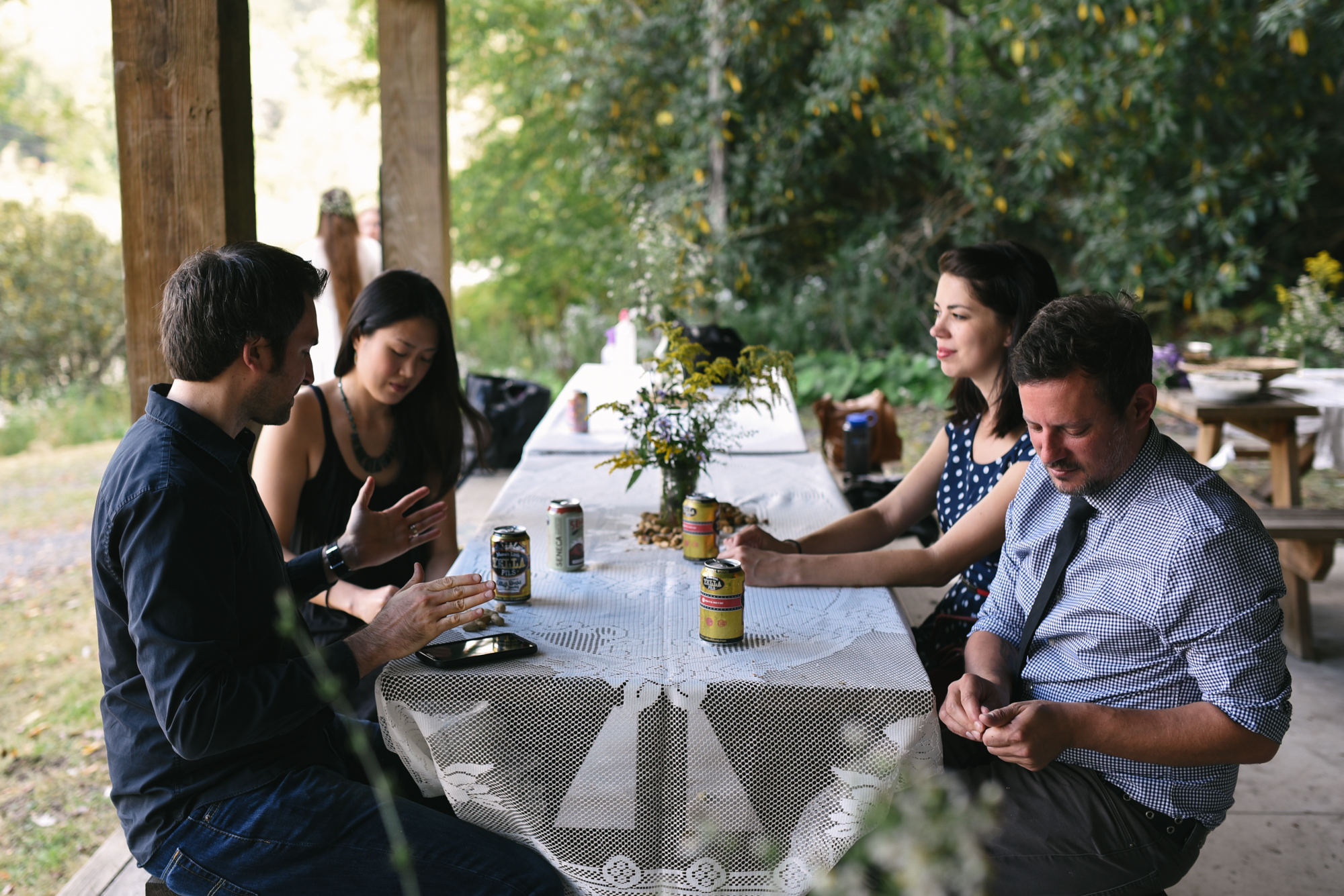  Mountain Wedding, Outdoors, Rustic, West Virginia, Maryland Wedding Photographer, DIY, Casual, Guests chatting at picnic table, wildflowers 