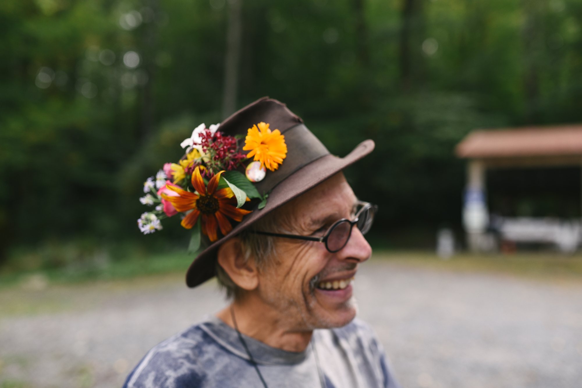  Mountain Wedding, Outdoors, Rustic, West Virginia, Maryland Wedding Photographer, DIY, Casual, Wedding Guest with flowers in his hat, guest smiling and laughing 