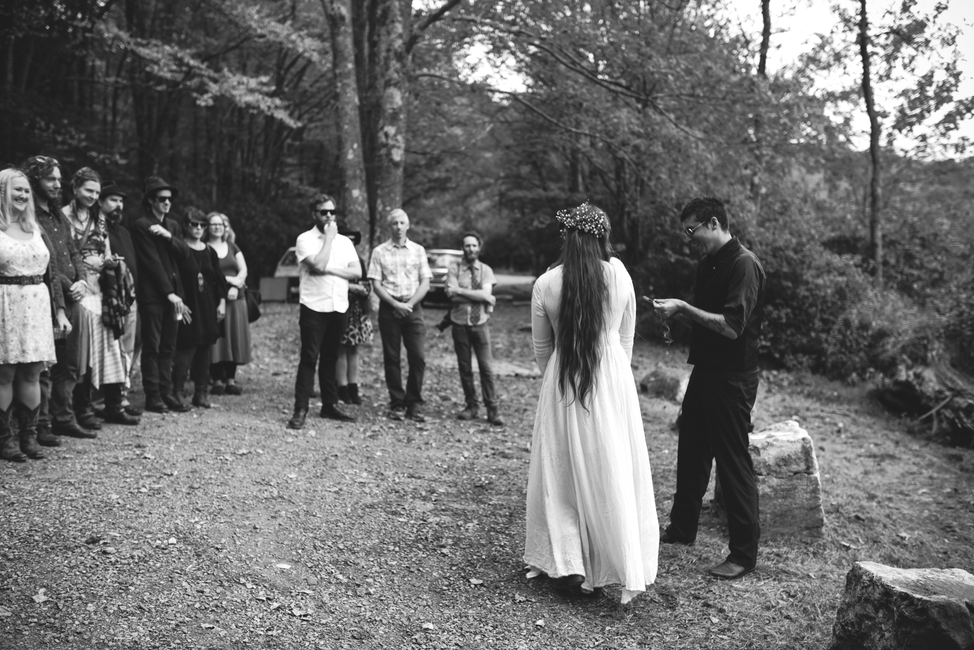  Mountain Wedding, Outdoors, Rustic, West Virginia, Maryland Wedding Photographer, DIY, Casual, guests gathered to watch ceremony, black and white ceremony, bride with long hair and flowers 