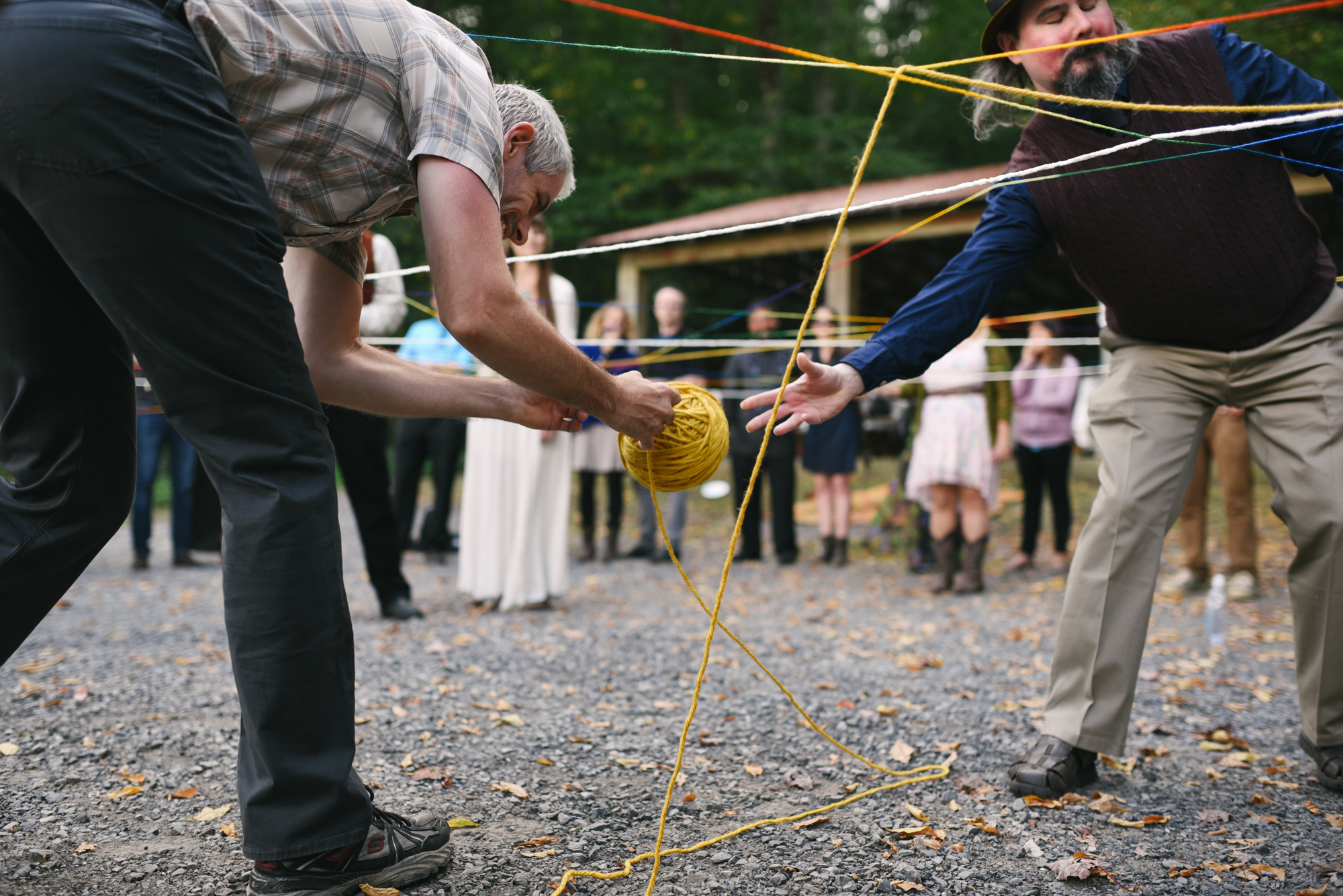  Mountain Wedding, Outdoors, Rustic, West Virginia, Maryland Wedding Photographer, DIY, Casual, Guests passing yarn at yarn weaving ceremony 