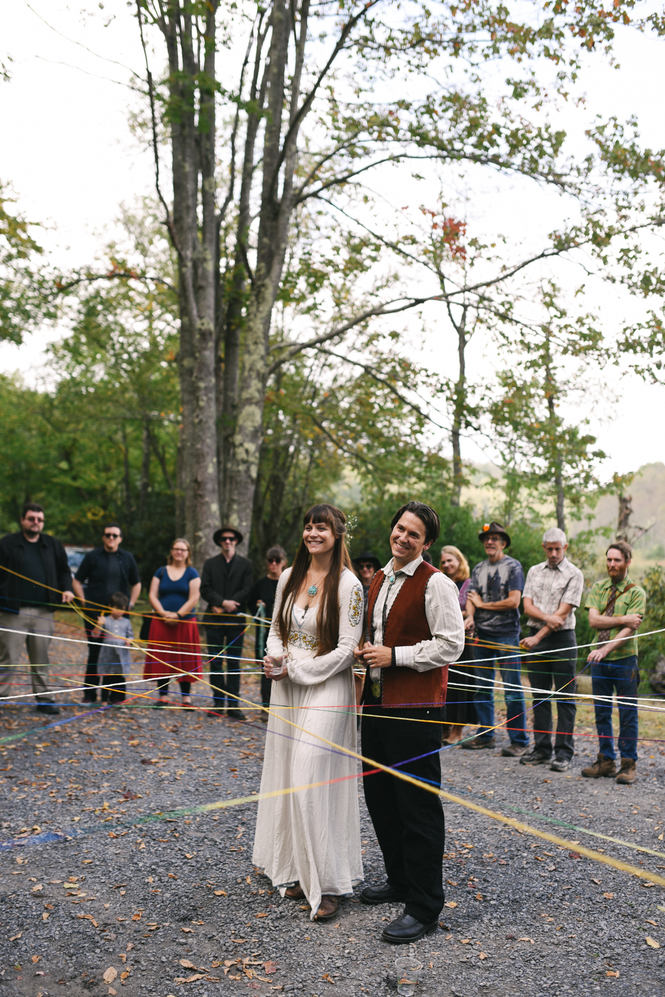  Mountain Wedding, Outdoors, Rustic, West Virginia, Maryland Wedding Photographer, DIY, Casual, bride and groom smiling together inside circle of friends, yarn ceremony 