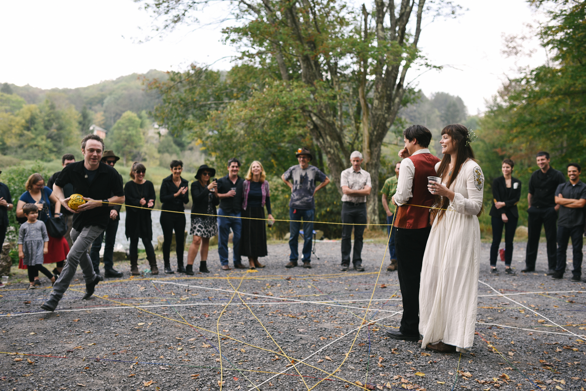  Mountain Wedding, Outdoors, Rustic, West Virginia, Maryland Wedding Photographer, DIY, Casual, bride and groom standing together being encircled with yarn, yarn weaving ceremony 