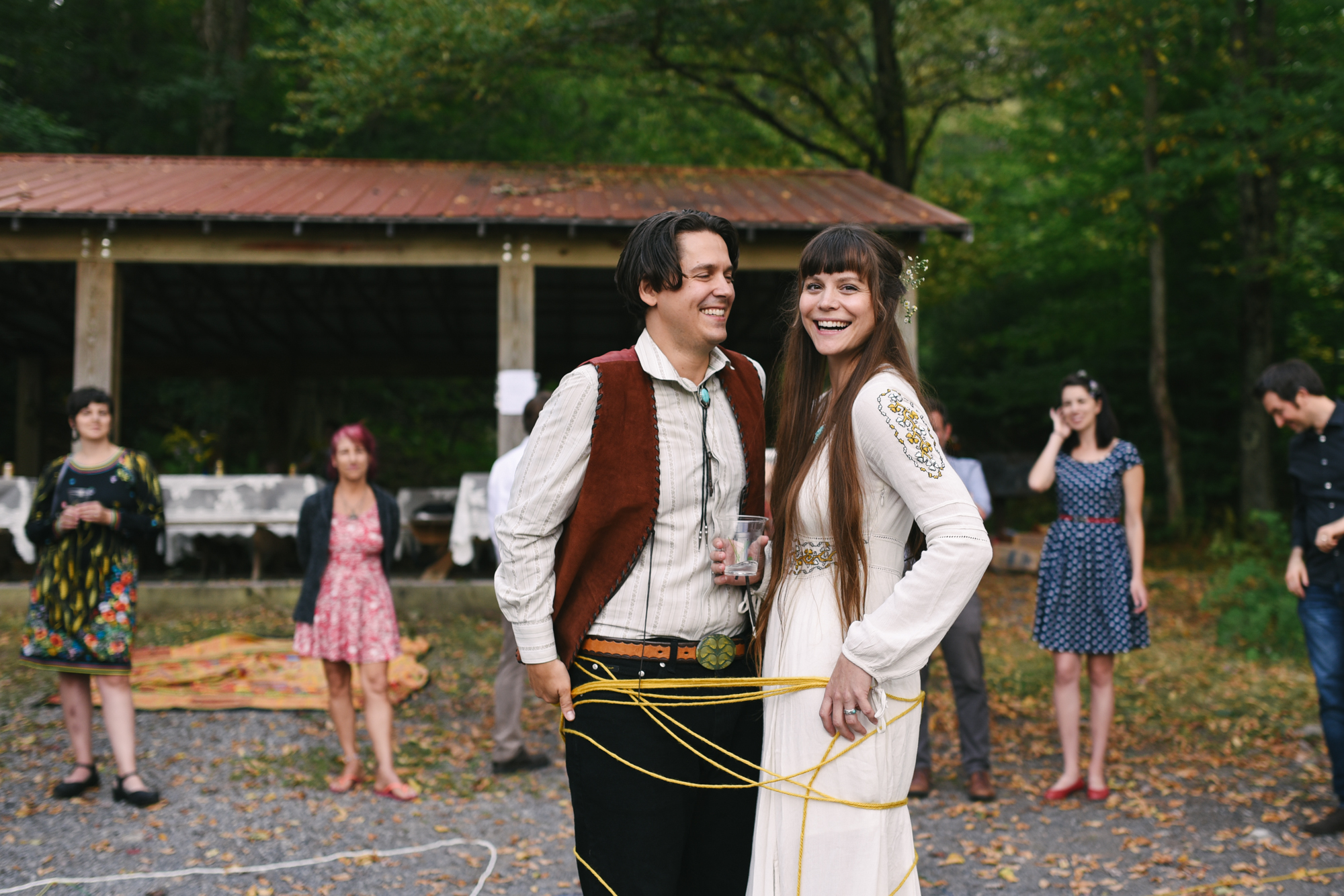  Mountain Wedding, Outdoors, Rustic, West Virginia, Maryland Wedding Photographer, DIY, Casual, bride and groom tied together with yarn, laughing and smiling together 