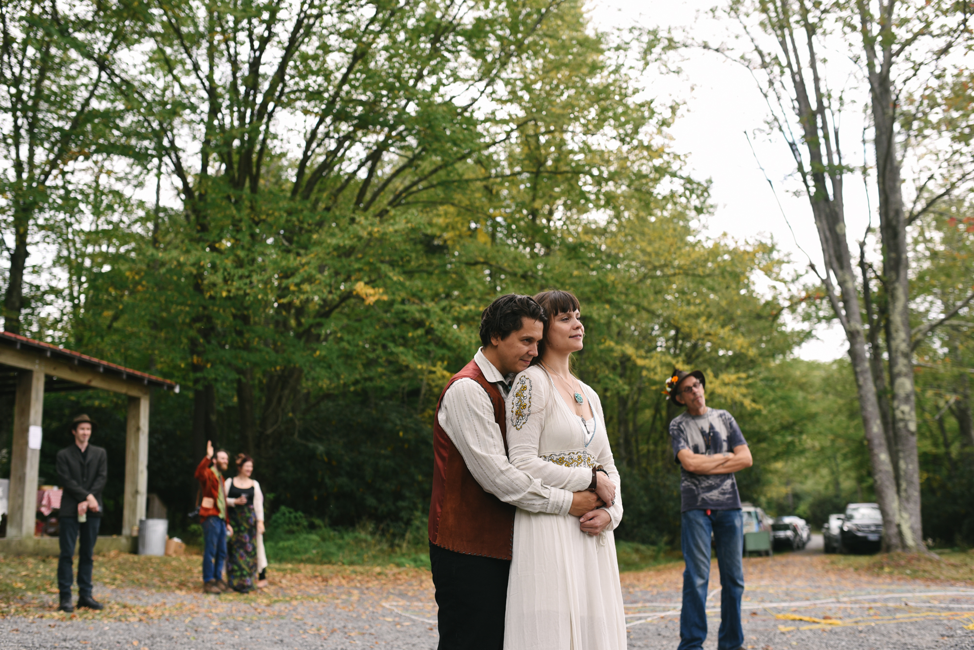  Mountain Wedding, Outdoors, Rustic, West Virginia, Maryland Wedding Photographer, DIY, Casual, groom holding bride from behind while watching musician 