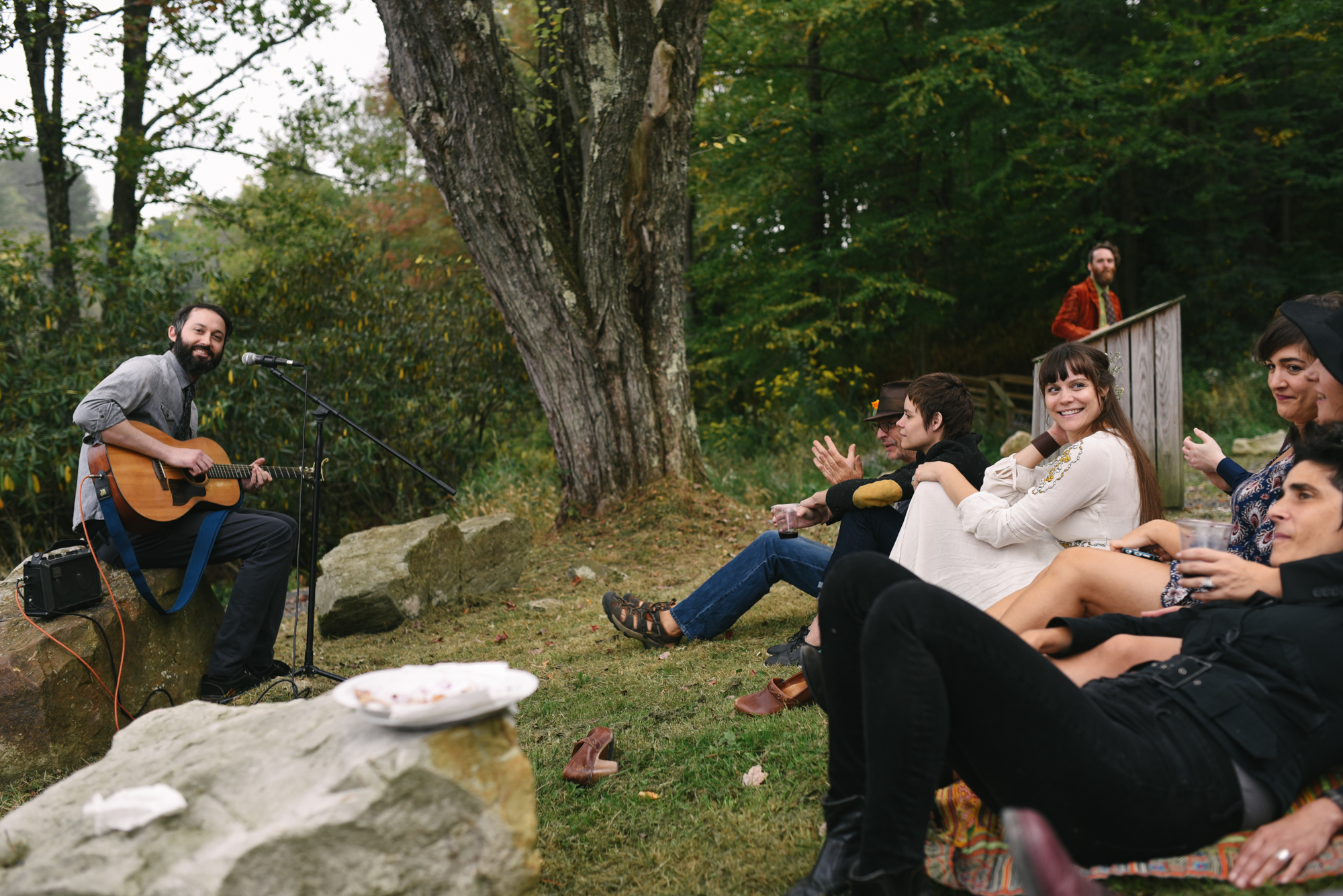  Mountain Wedding, Outdoors, Rustic, West Virginia, Maryland Wedding Photographer, DIY, Casual, guests sitting in grass outside, friend playing guitar 