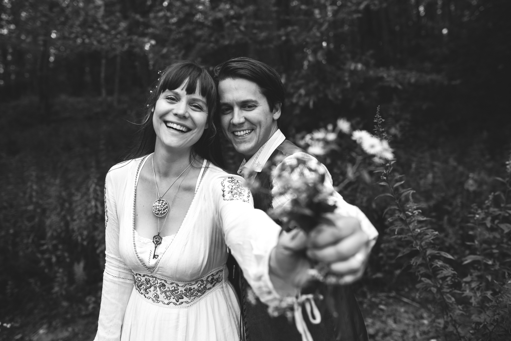  Mountain Wedding, Outdoors, Rustic, West Virginia, Maryland Wedding Photographer, DIY, Casual, black and white photo, bride and groom smiling and holding wildflowers 
