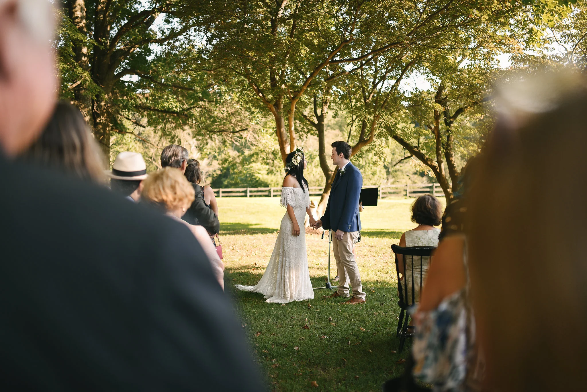 Maryland, Eastern Shore, Baltimore Wedding Photographer, Romantic, Boho, Backyard Wedding, Nature, Bride and Groom Holding Hands at Ceremony, Daughters of Simone Wedding Dress