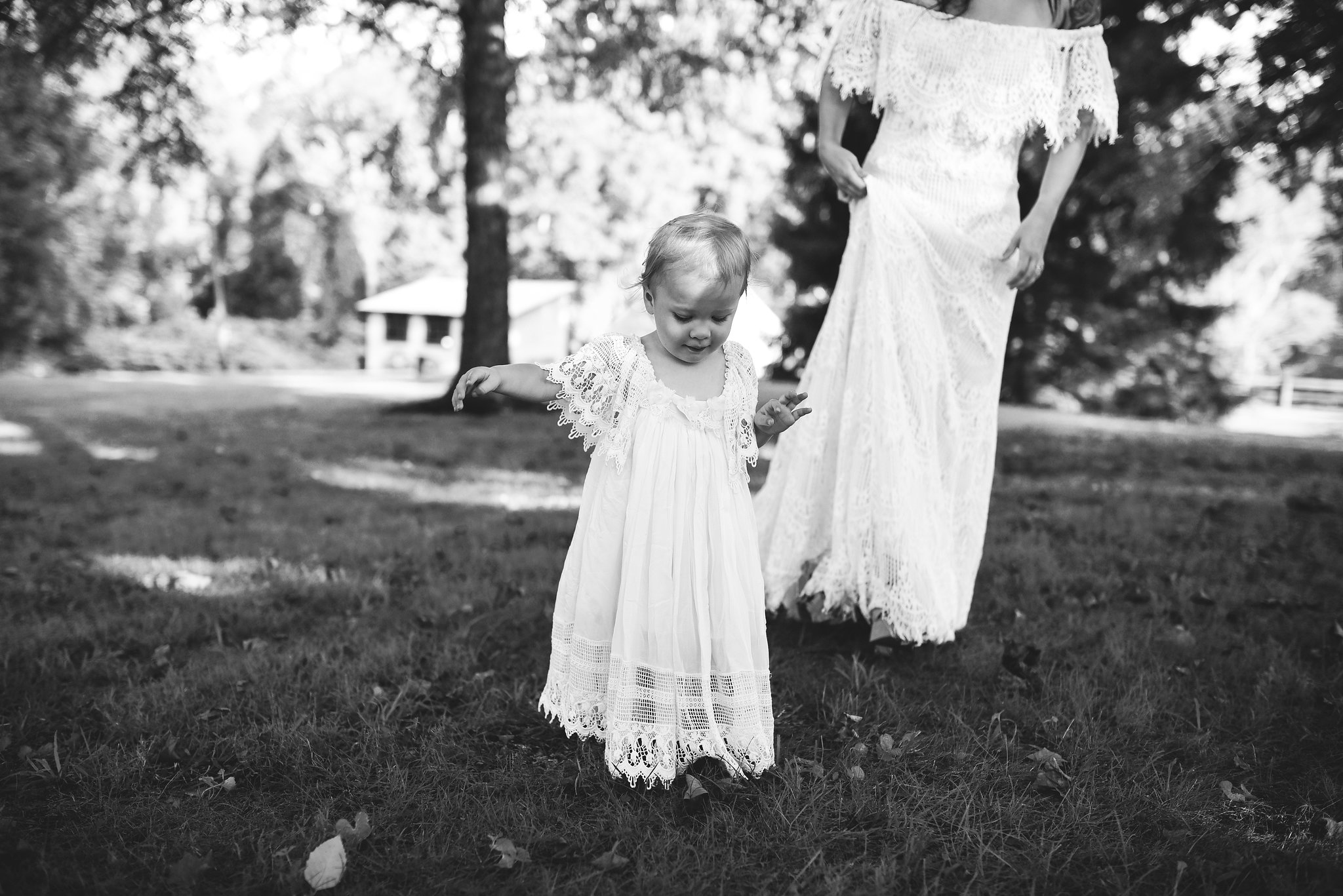 Maryland, Eastern Shore, Baltimore Wedding Photographer, Romantic, Boho, Backyard Wedding, Nature, Bride Walking with Flower Girl in Lace Dress, Black and White Photo 