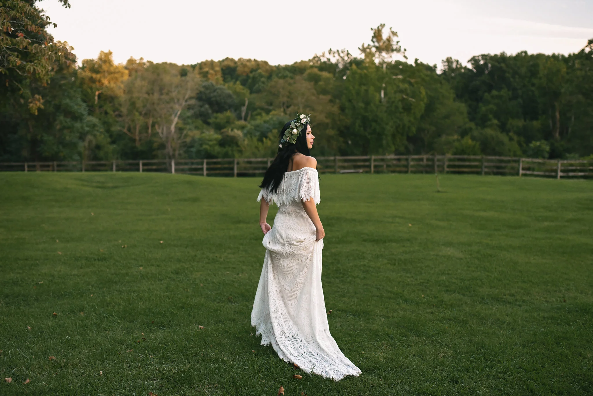 Maryland, Eastern Shore, Baltimore Wedding Photographer, Romantic, Boho, Backyard Wedding, Nature, Candid Photo of Bride Walking Through Field, Lace Daughters of Simone Wedding Dress, Flower Crown Michael Designs Florist