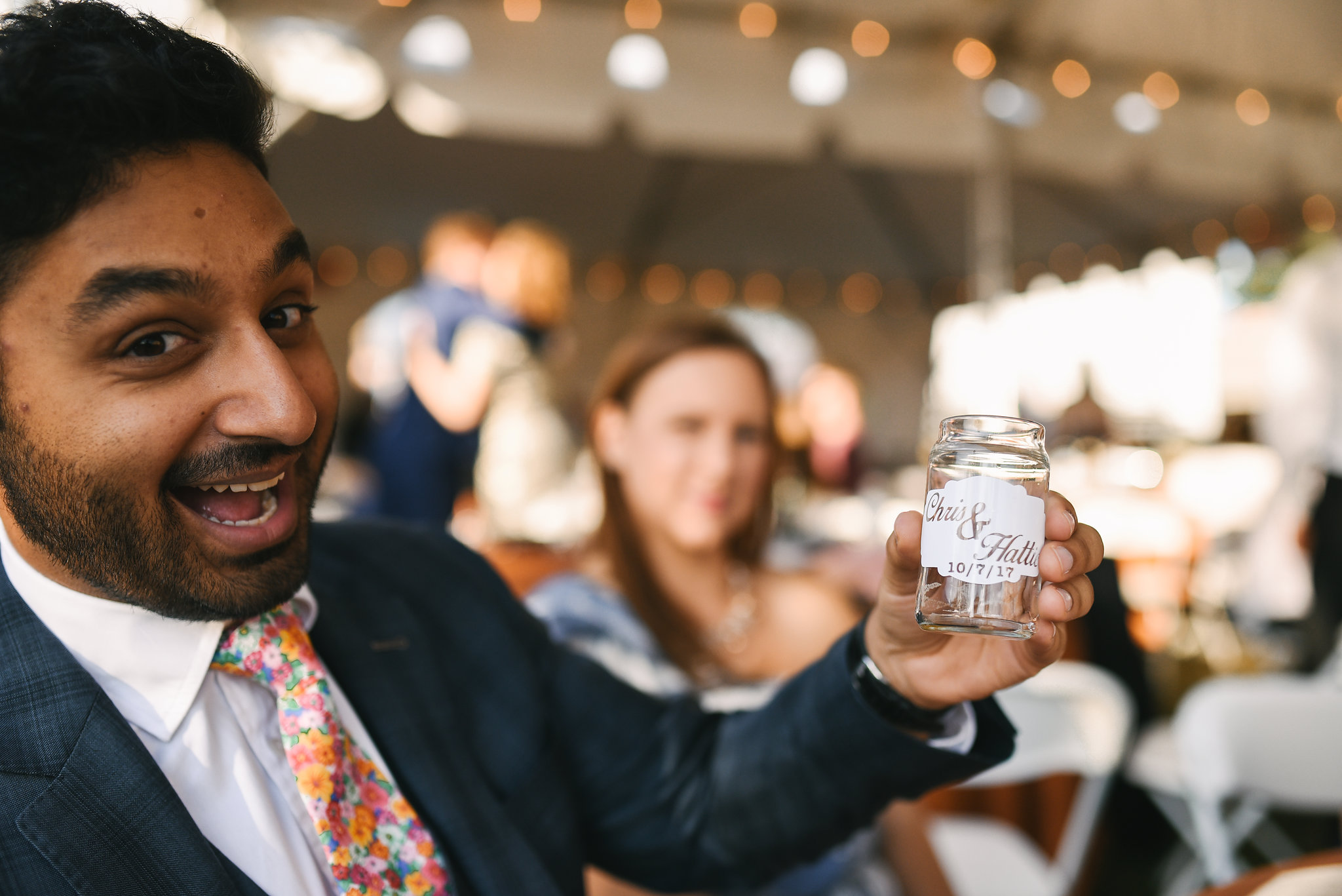  Baltimore, Canton, Modern, Outdoor Reception, Maryland Wedding Photographer, Romantic, Classic, Boston Street Pier Park, Wedding guest smiling and holding custom beer glass 