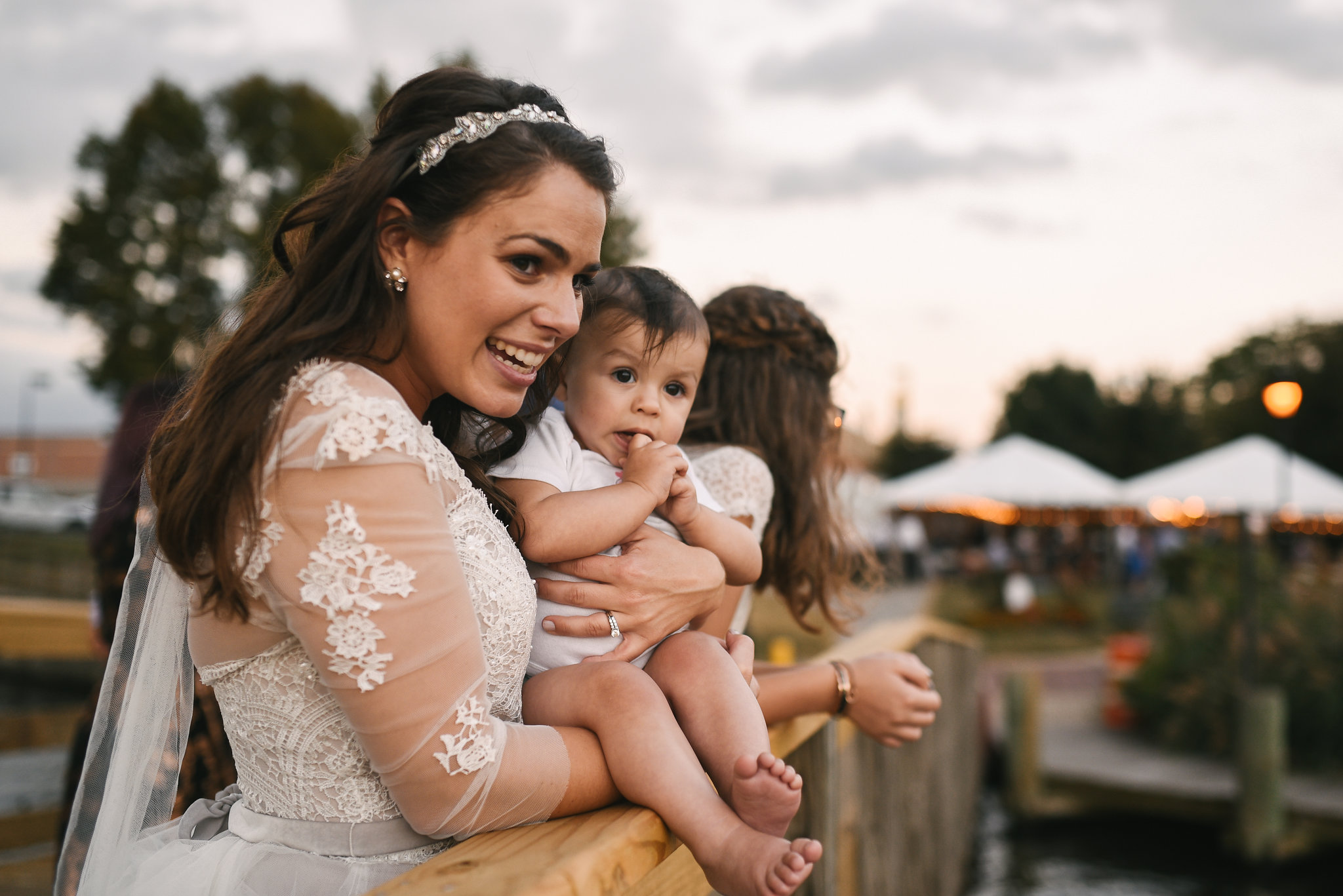  Baltimore, Canton, Modern, Outdoor Reception, Maryland Wedding Photographer, Romantic, Classic, Boston Street Pier Park, Bride holding baby at waterfront, lace wedding dress 