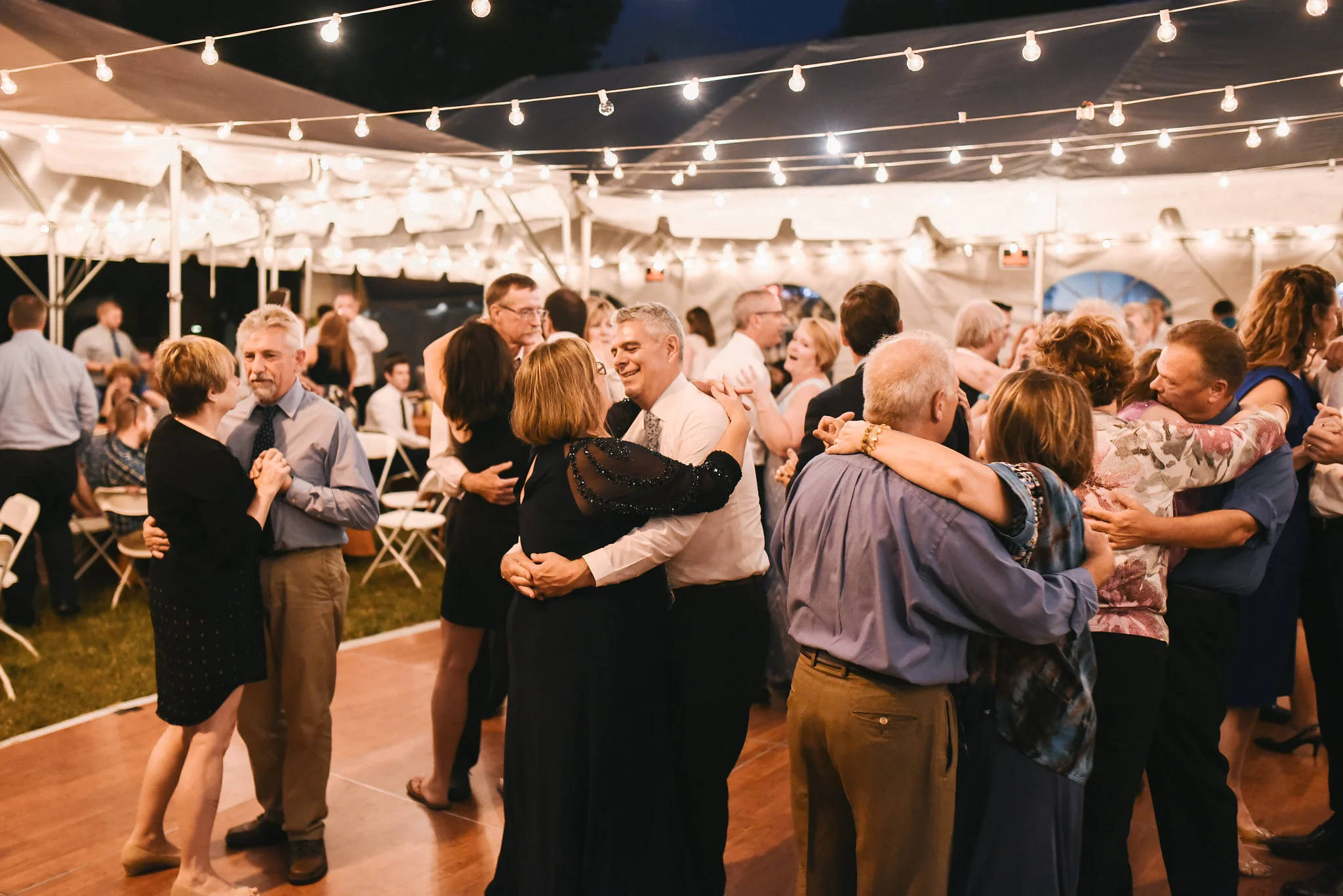 Baltimore, Canton, Modern, Outdoor Reception, Maryland Wedding Photographer, Romantic, Classic, Boston Street Pier Park, Guests slow dancing under string lights, Outside in the evening