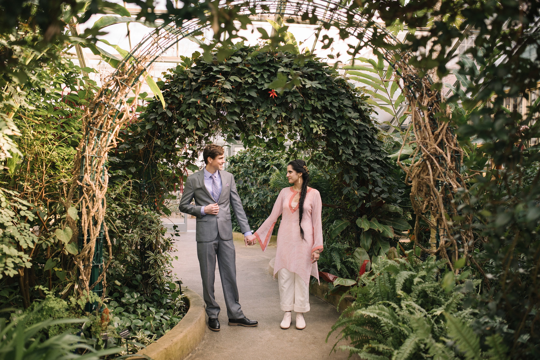 Elopement, Rawlings Conservatory, Greenhouse, Baltimore Wedding Photographer, Indian American, Outdoor, Nature, Romantic, Garden, Floral Archway, Bride and Groom Holding Hands, Sari, Gray Suit