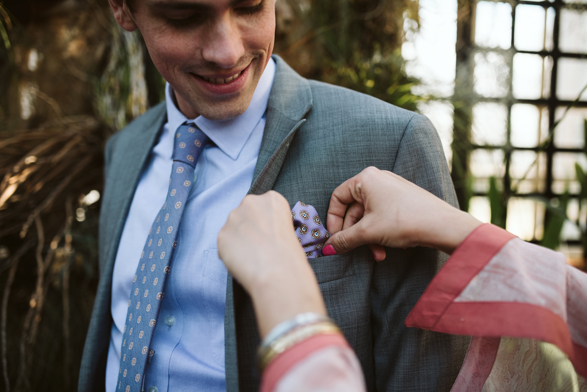 Elopement, Weekday Wedding, Baltimore, Rawlings Conservatory, Greenhouse, Maryland Wedding Photographer, Indian American, Nature, Romantic, Garden, Bride Adjusting Grooms Suit, Gray Suit