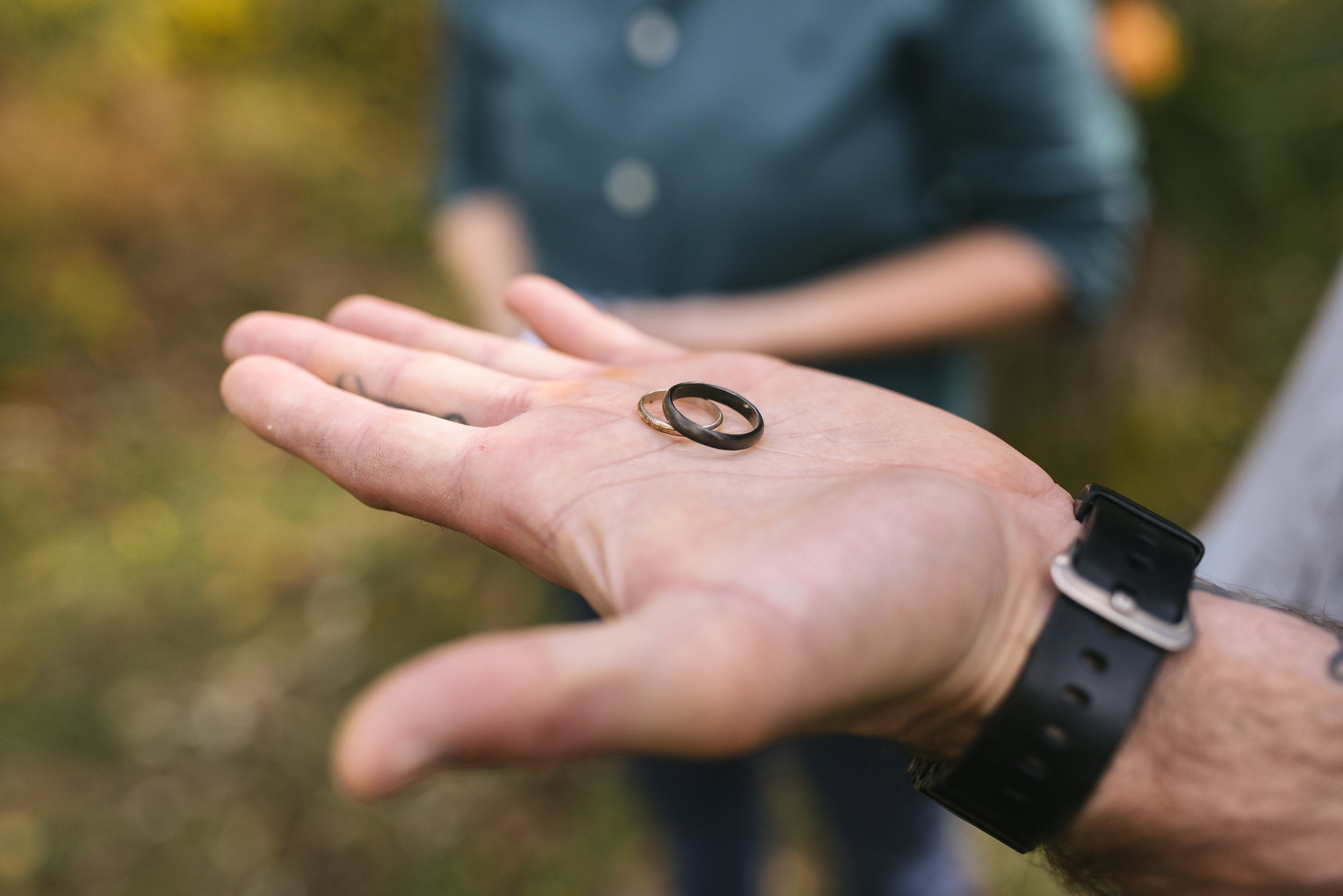 Baltimore, Maryland Wedding Photographer, Backyard Wedding, DIY, Rustic, Casual, Fall Wedding, Woodland, Groom Holding Wedding Rings in Palm of his Hand, Artifactum Designs