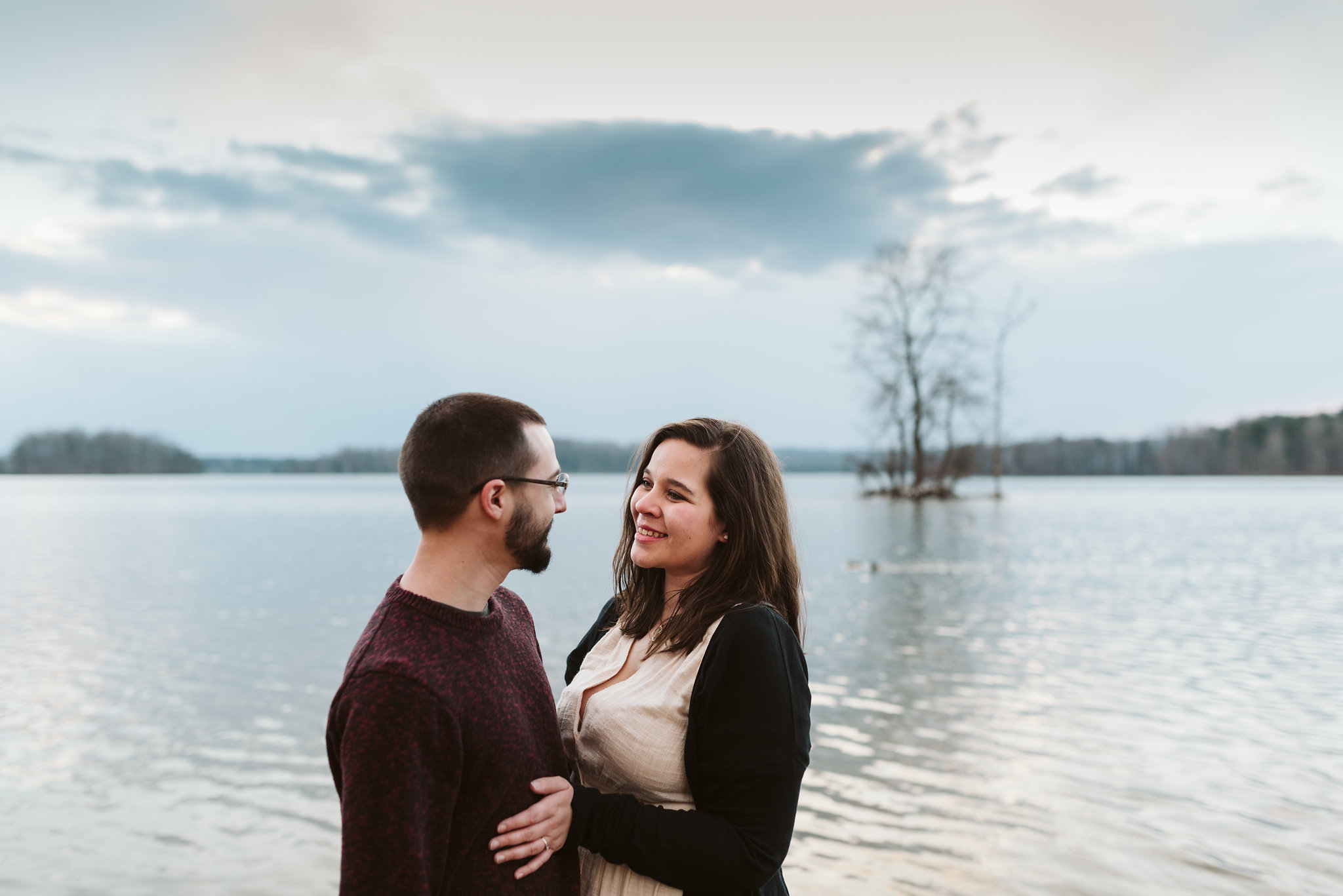  Baltimore County, Loch Raven Reservoir, Maryland Wedding Photographer, Winter, Engagement Photos, Nature, Romantic, Bride and Groom Smiling at Each Other in Front of Water, Outdoors, Rustic 