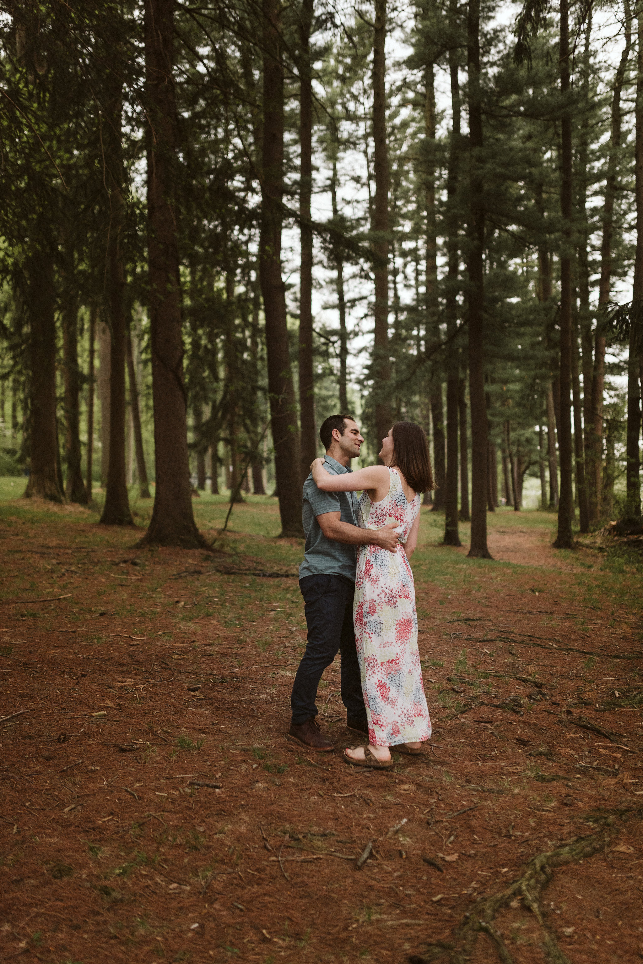 bride and groom dancing in the middle of the woods around pine trees