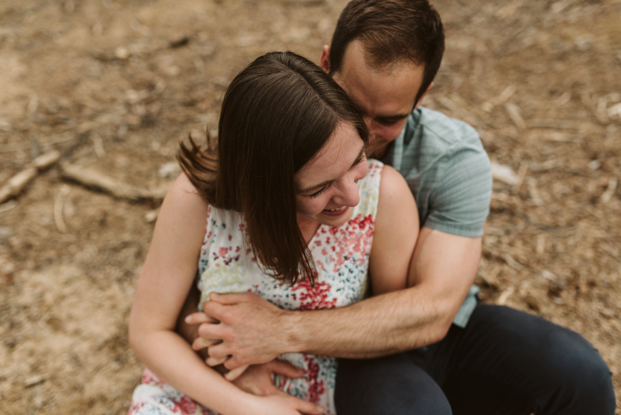 intimate overhead shot of bride and groom giggling and being romantic